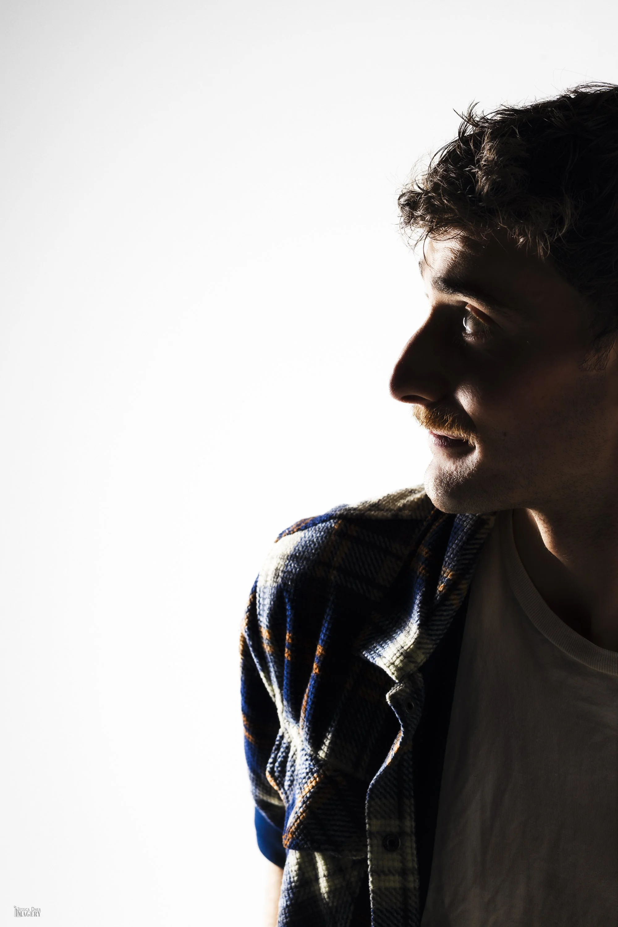 Studio portrait with simple background and strong expression koy dj Denver