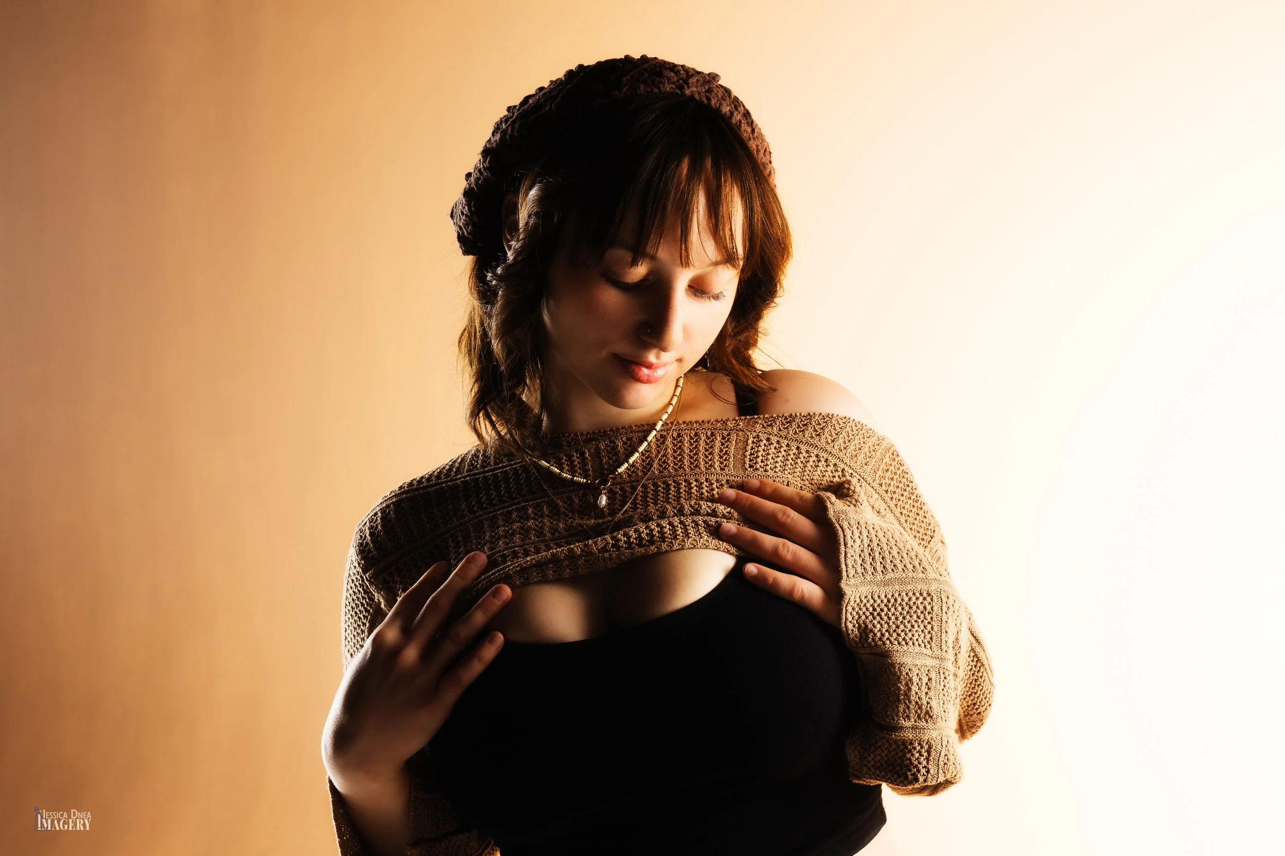 Denver studio portrait with warm dramatic lighting, soft expression, creative styling, and polished editing for personal portraits, branding, and professional use.