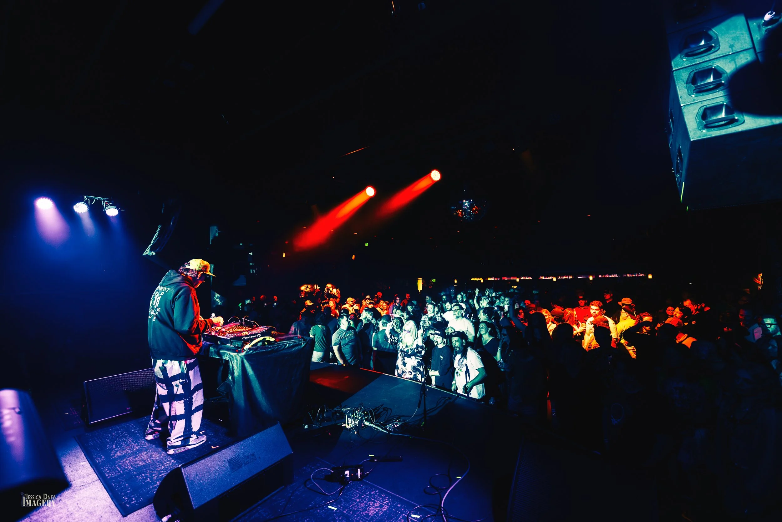 DJ Brownie performs from the Cervantes stage before a packed audience during a 2026 Denver concert, photographed from behind the performer.