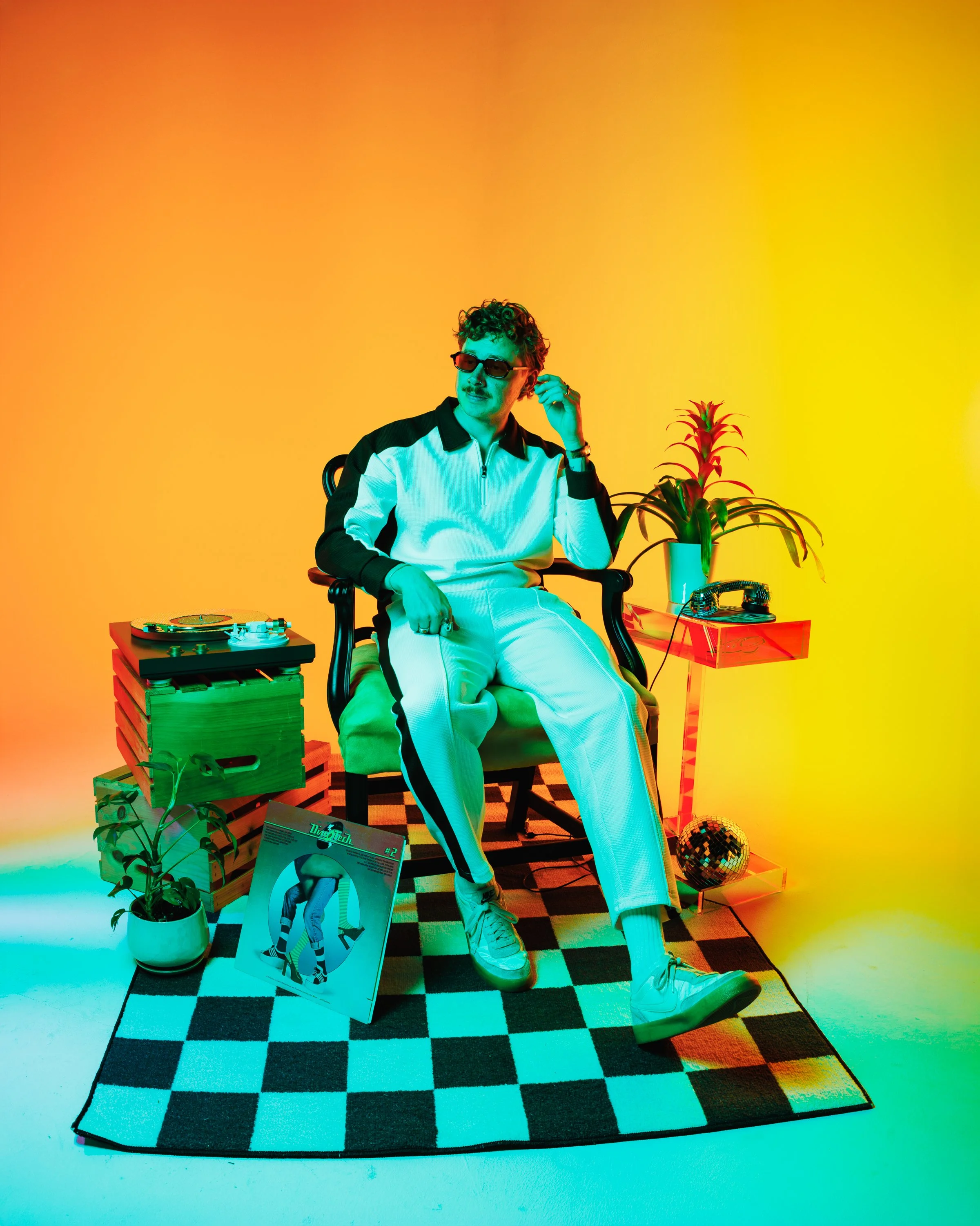 Denver musician press portrait with bold green, orange, and yellow studio lighting, retro props, and colorful creative direction for artist branding, releases, EPKs, and promotional campaigns.