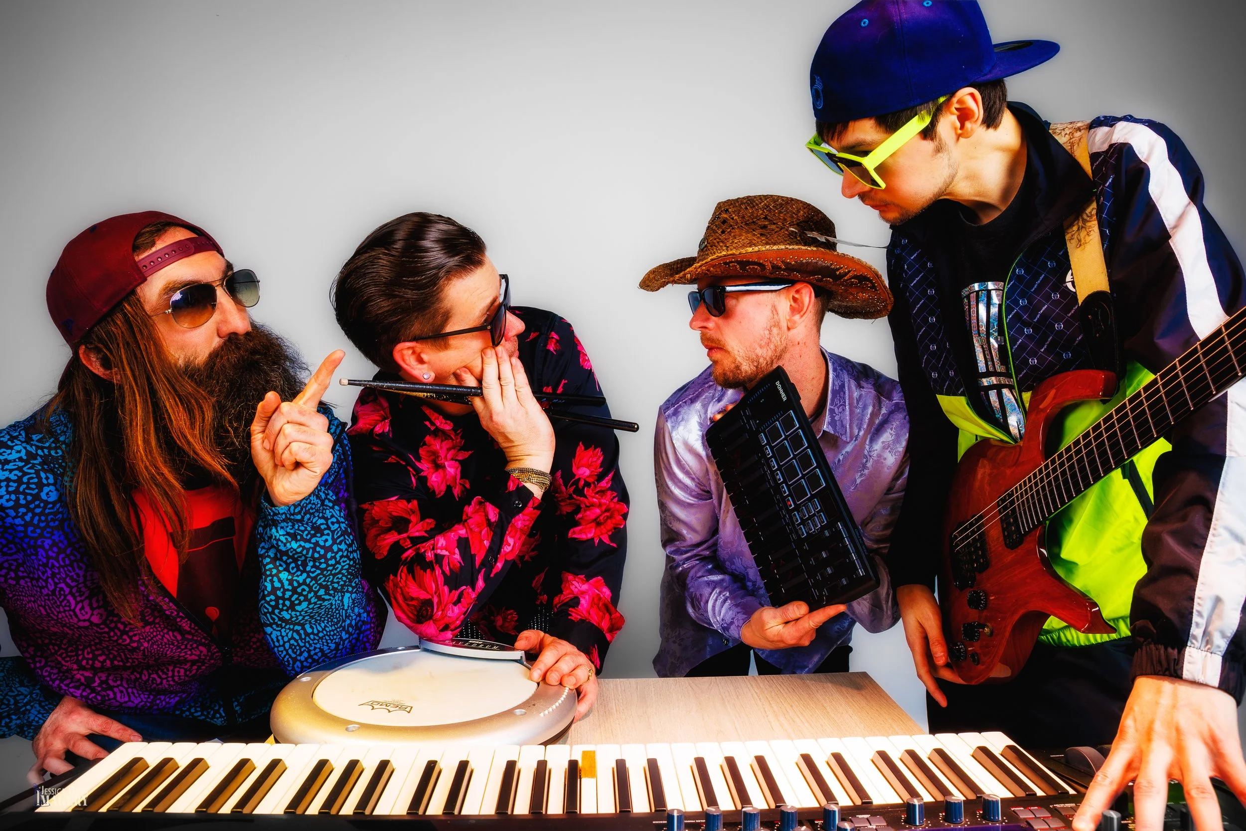 Colorful band press photo featuring keyboards, guitar, percussion and client-supplied instruments in a Denver studio.