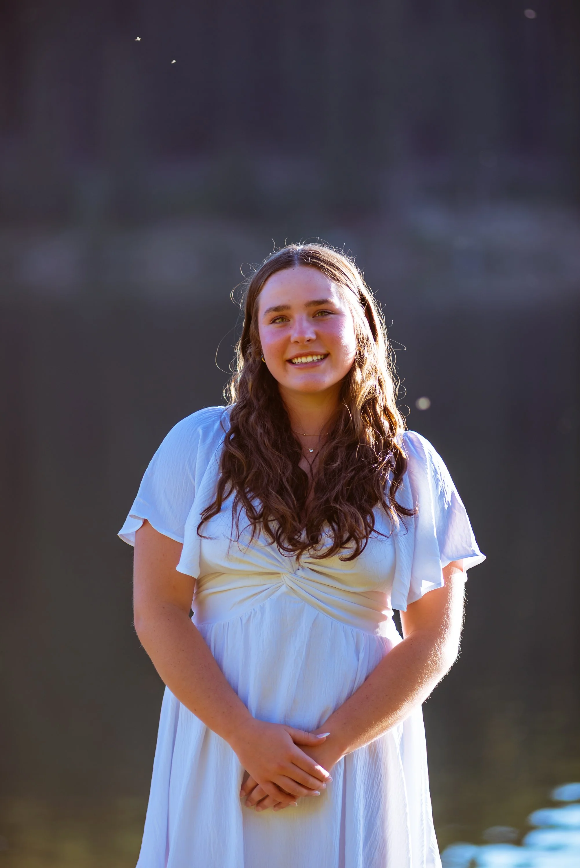 Colorado senior pictures by Jessica Dnea Imagery with mountain views, colorful wildflowers, personal style, relaxed posing, and edited high-resolution graduation portraits.