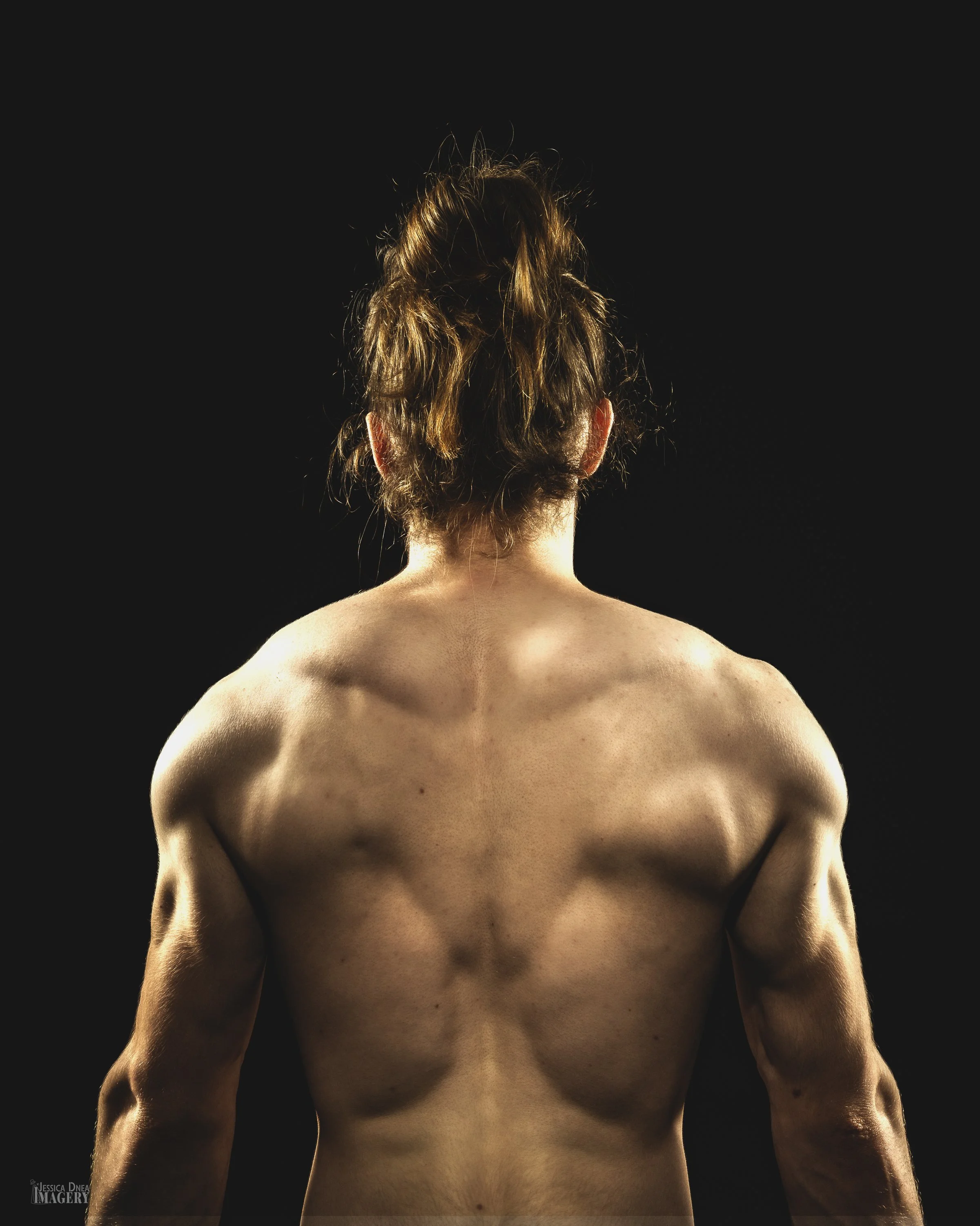 Editorial-style studio portrait with intentional lighting Alder Bloomfield