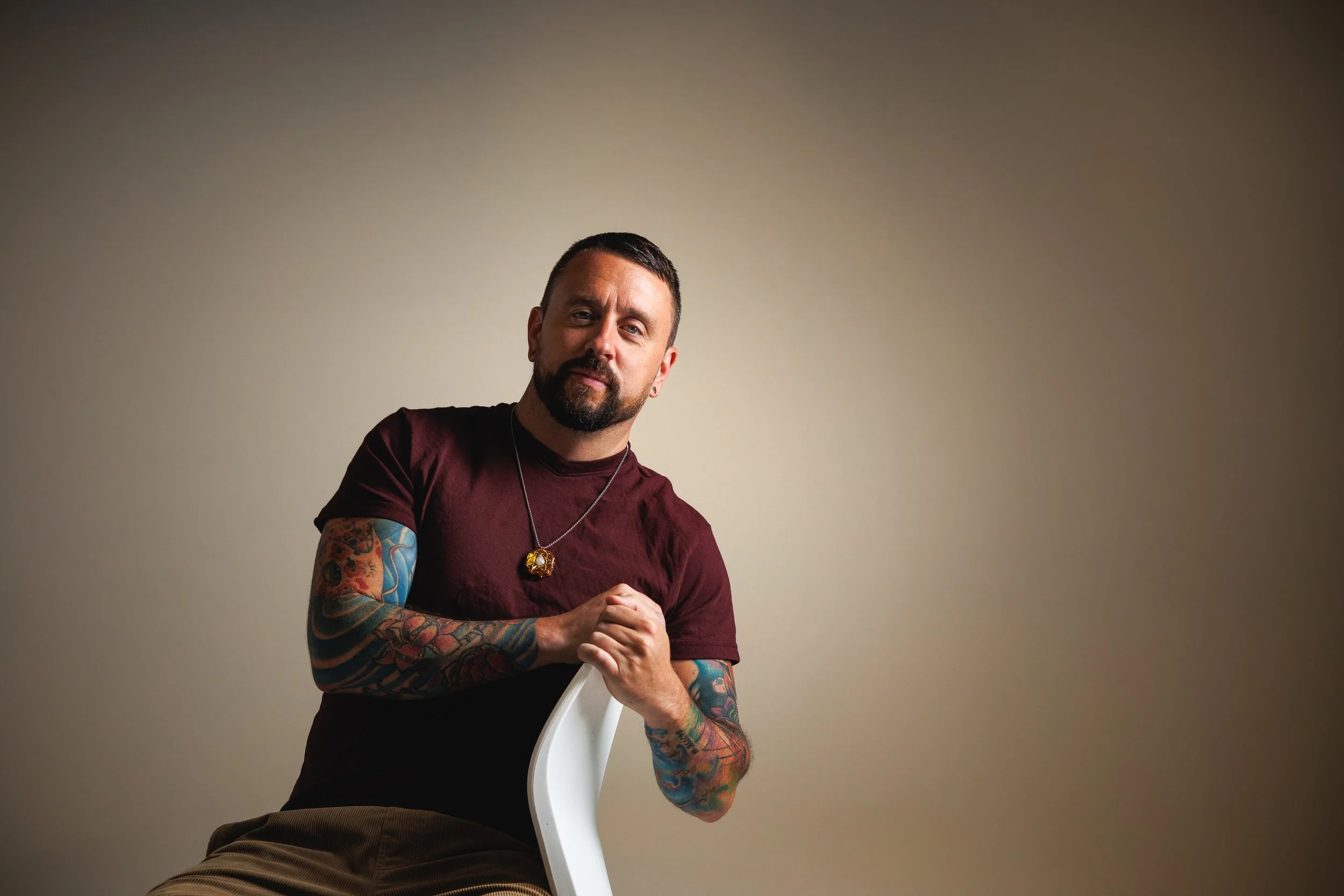 Denver personal branding portrait with clean studio lighting, relaxed posing, negative space, and a polished professional look for websites, profiles, social media, and business marketing.