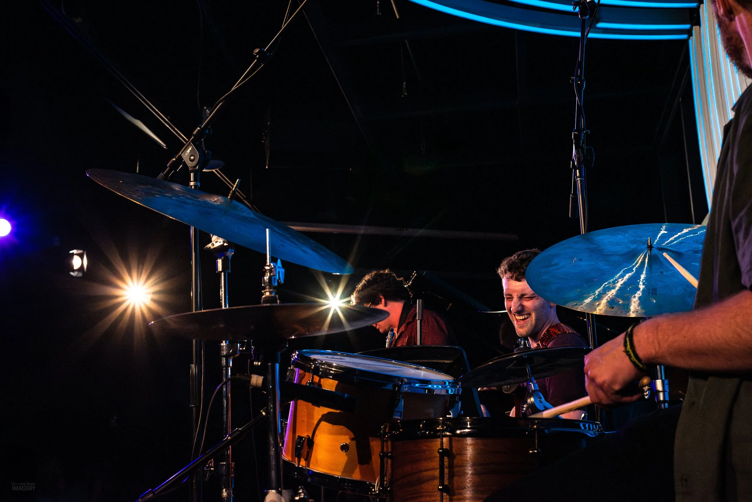 Concert camera settings for low-light live music photography with f/8 starburst lighting, ISO 3200, and 1/125 shutter speed.