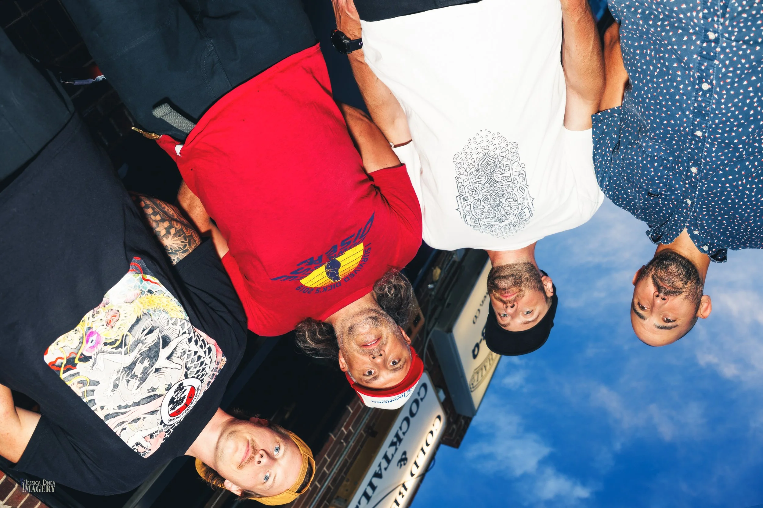 Creative rotated group portrait of Parky Jobbins outside Globe Hall for posters, social media and venue promotion.