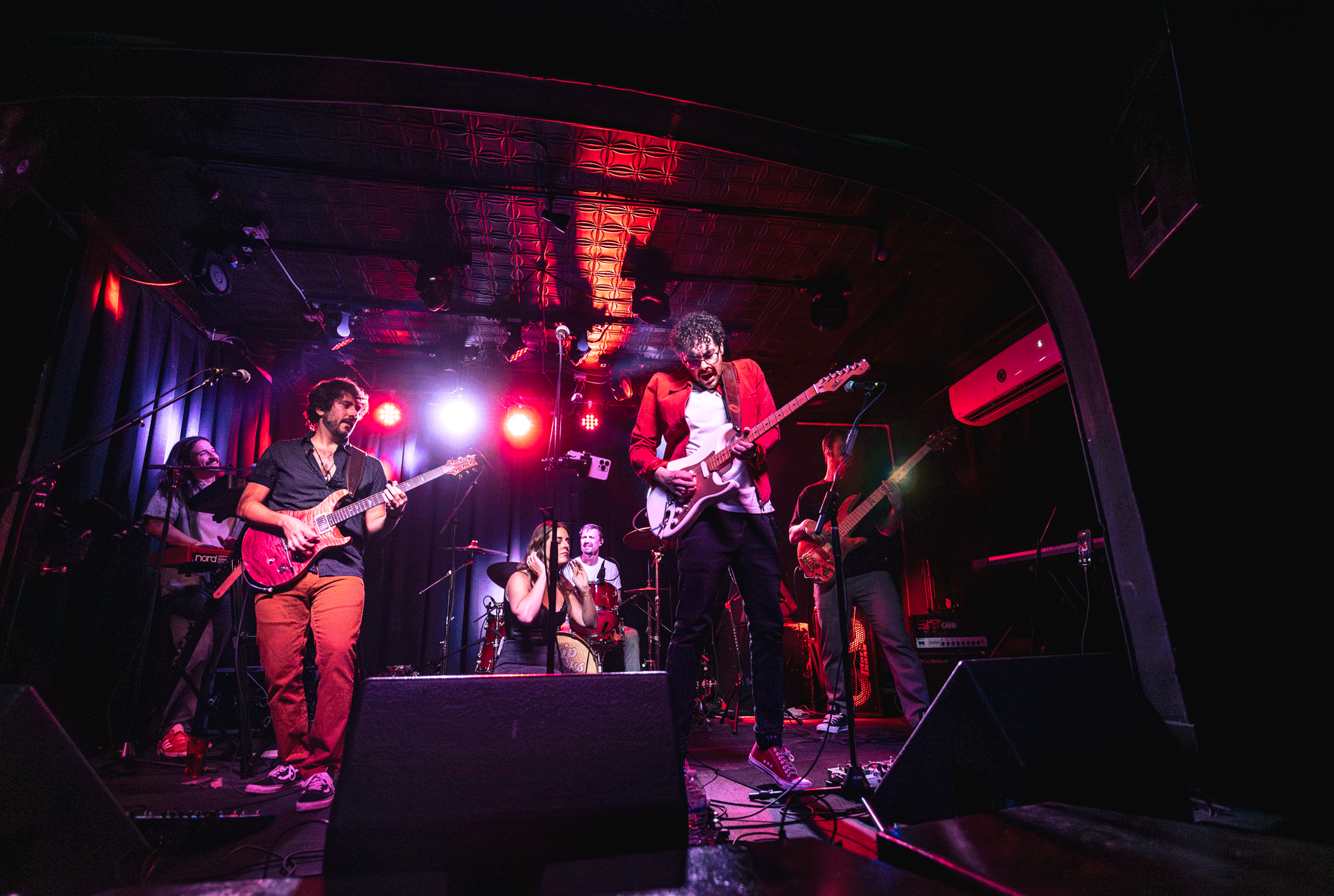 Live show photo with stage lighting and venue atmosphere Hip Snacks