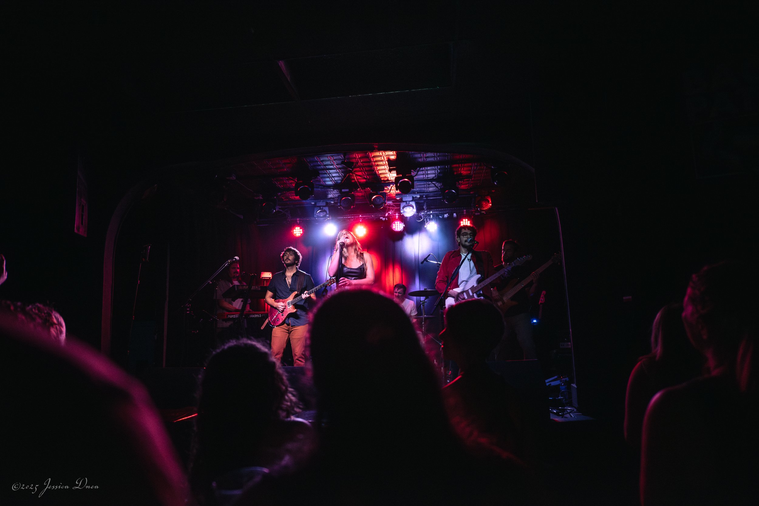 Live show photo with stage lighting and venue atmosphere