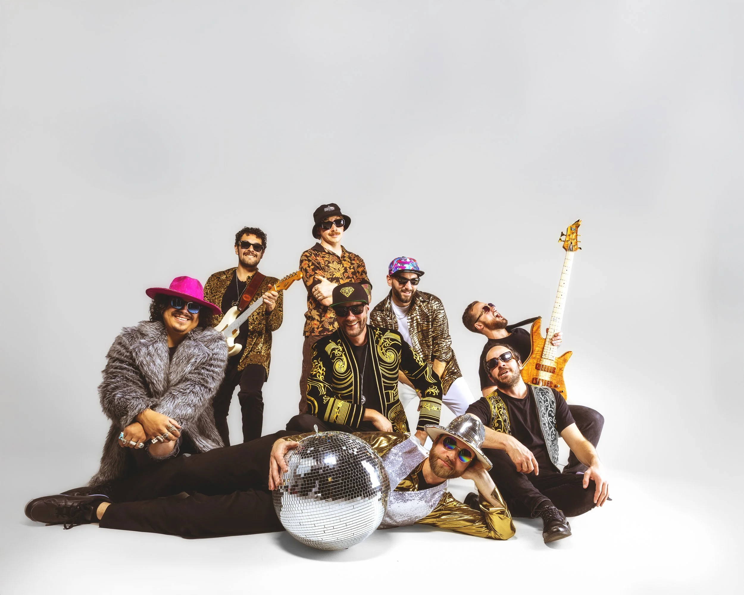All-white studio band portrait showing the clean original before creative color editing for music promotion.