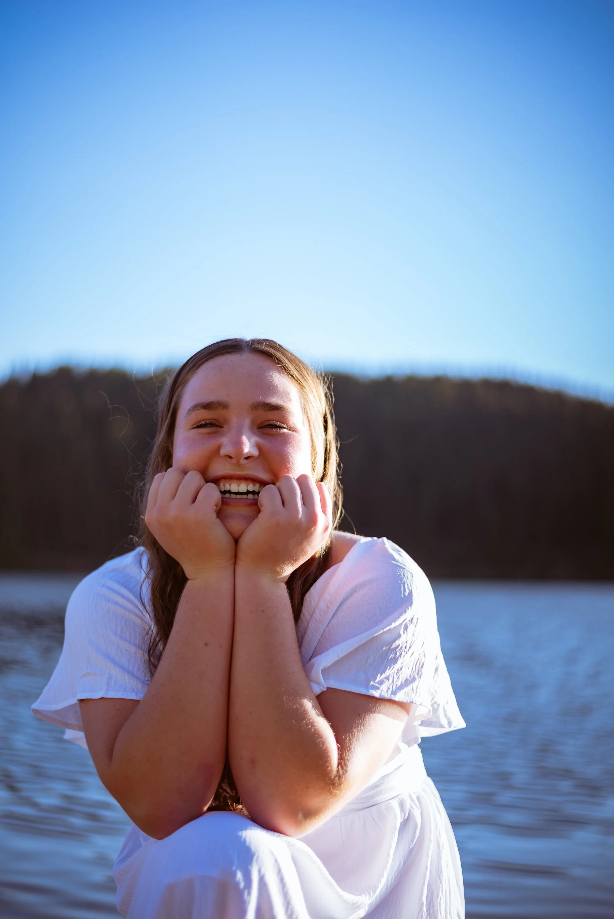 Colorado senior portraits in the mountains by Jessica Dnea Imagery with wildflowers, lakeside views, soft natural light, relaxed posing, and graduation-ready images.
