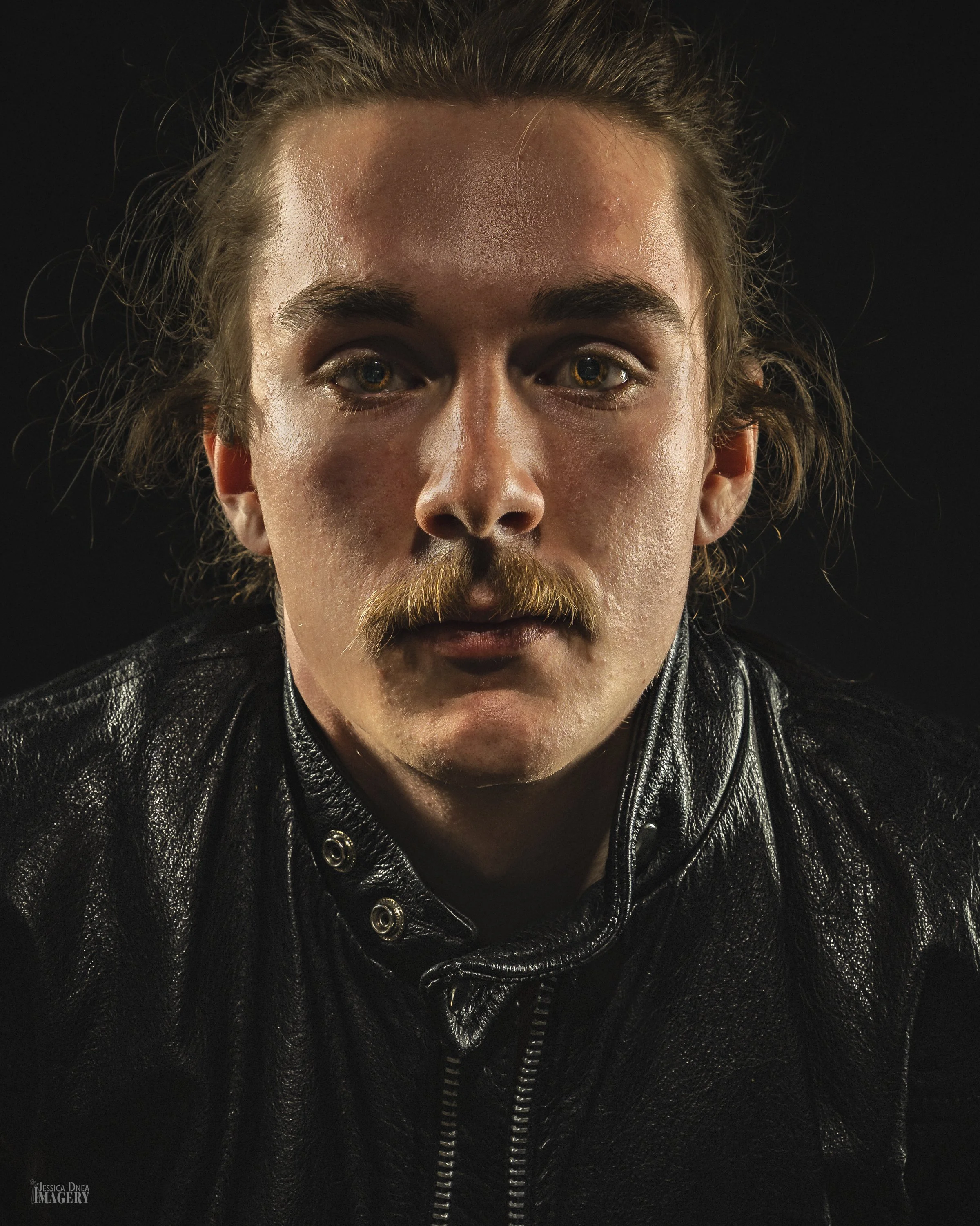 Studio portrait with simple background and strong expression Alder Bloomfield