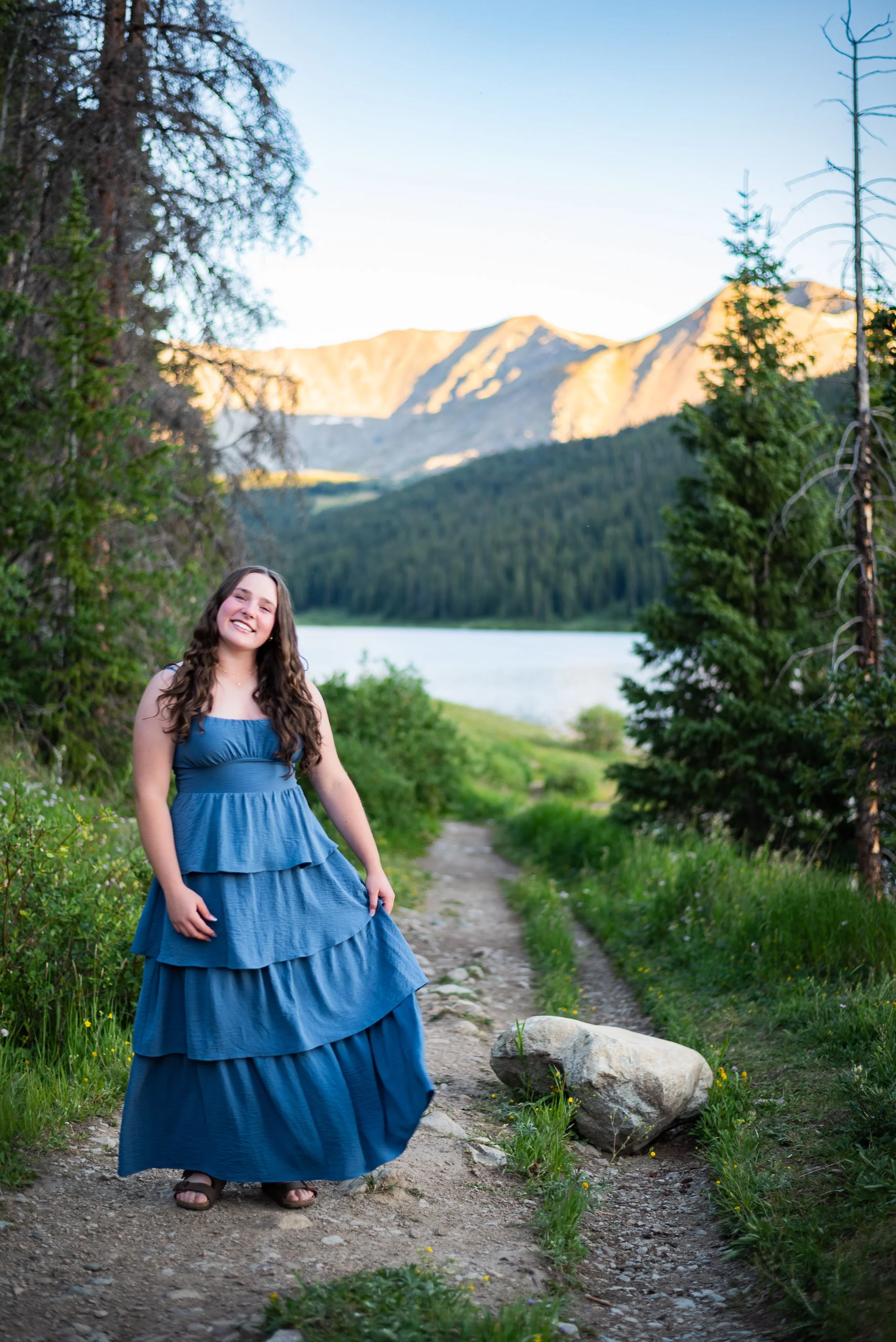 Colorado mountain senior photos by Jessica Dnea Imagery with wildflowers, alpine views, natural light, relaxed posing, and scenic outdoor graduation portraits.