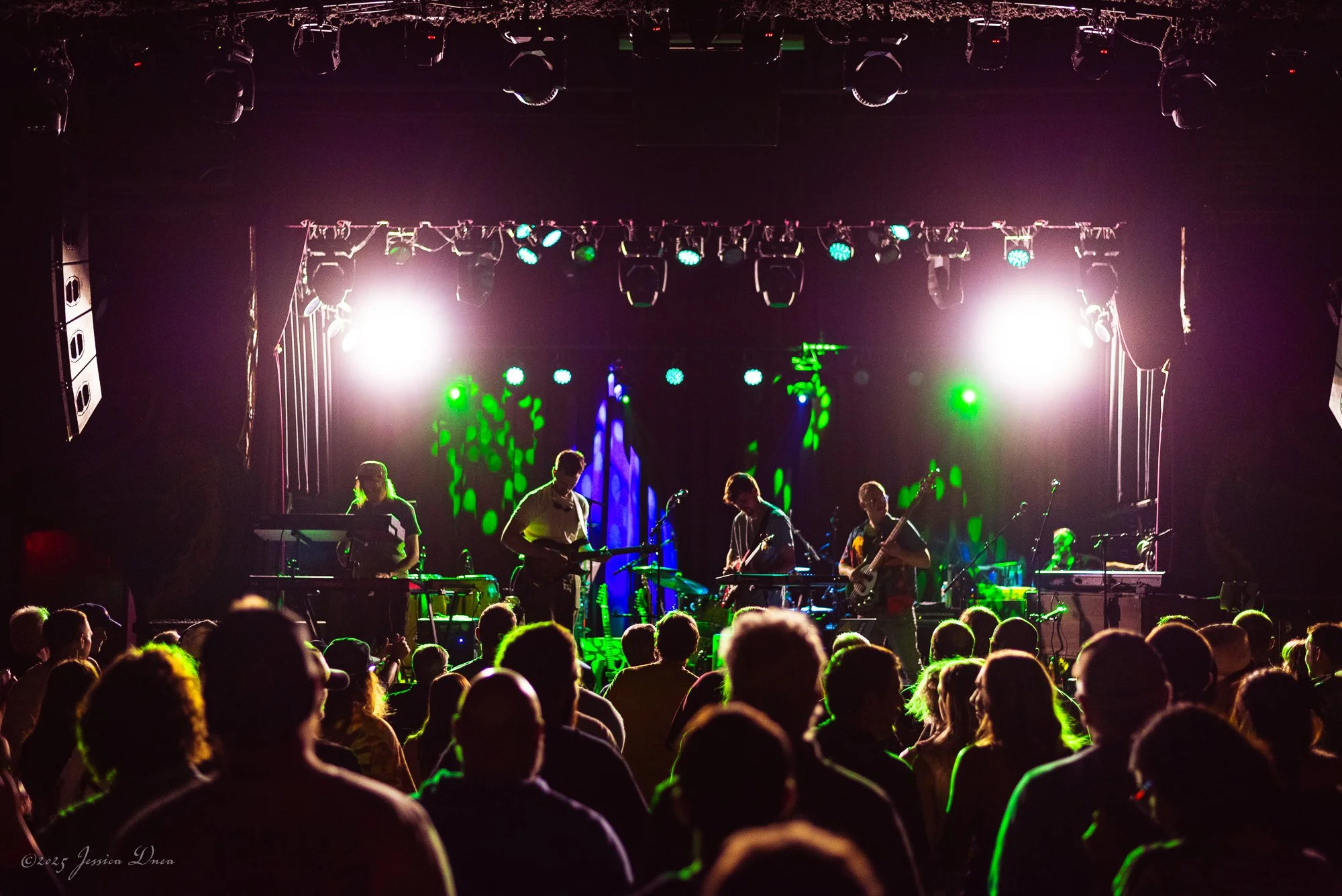 Live show photo with stage lighting and venue atmosphere
