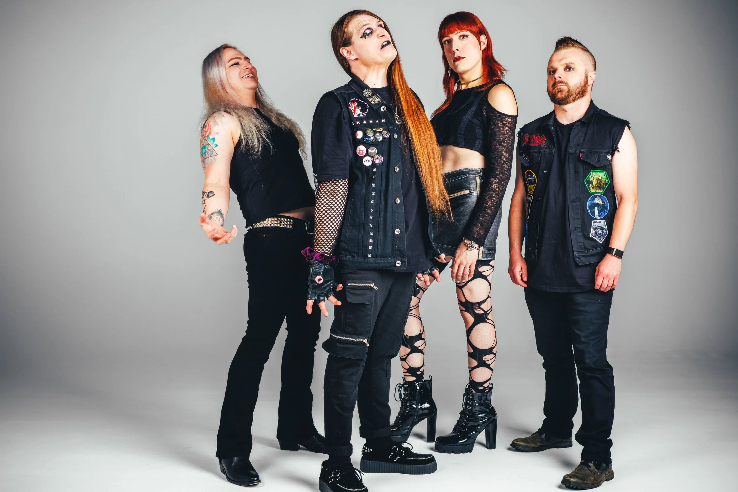 Full-length metal band portrait on an all-white cyc wall for EPKs, websites and graphic design.