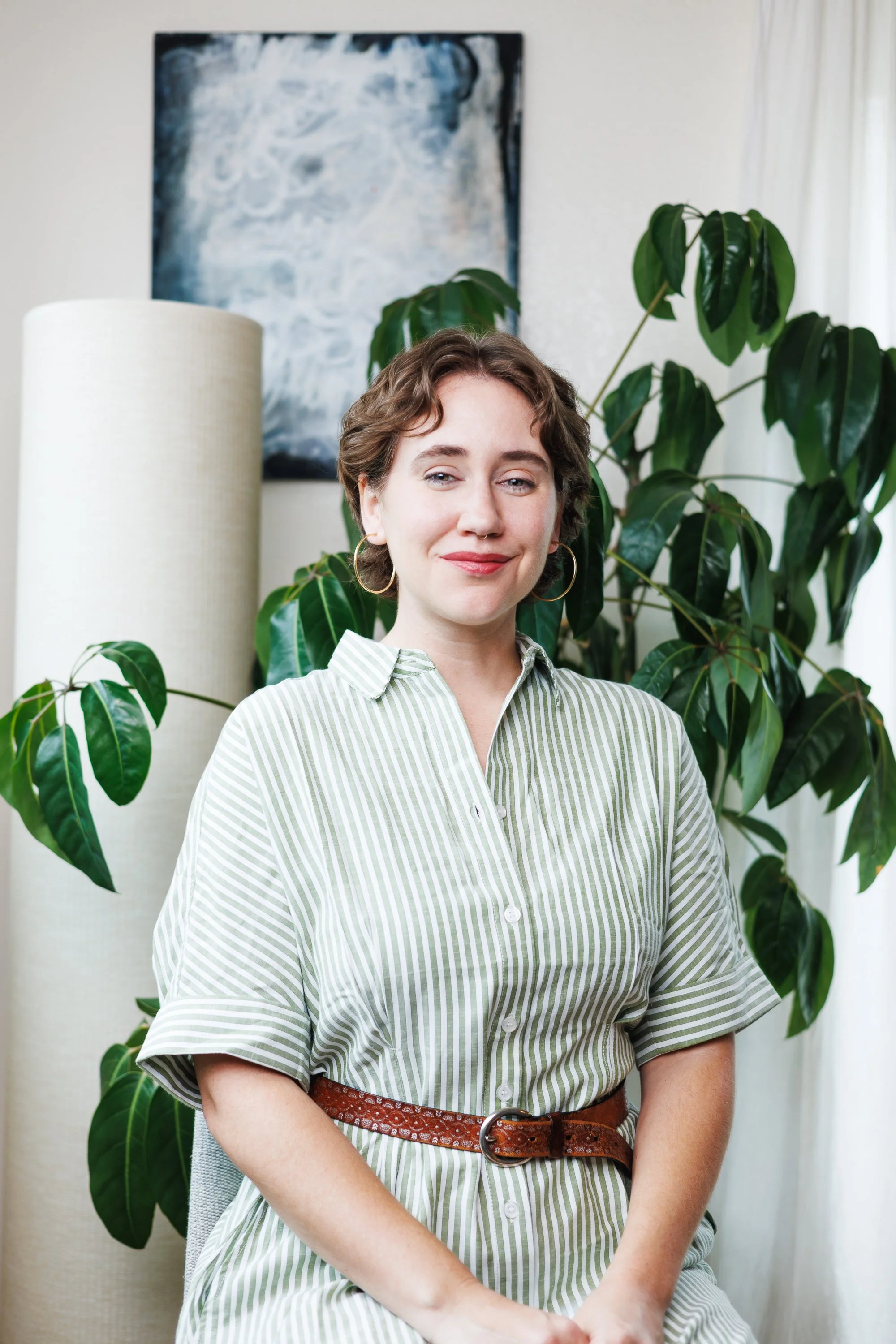 Individual Lyyra press portrait in a bright styled home studio with plants and natural décor.