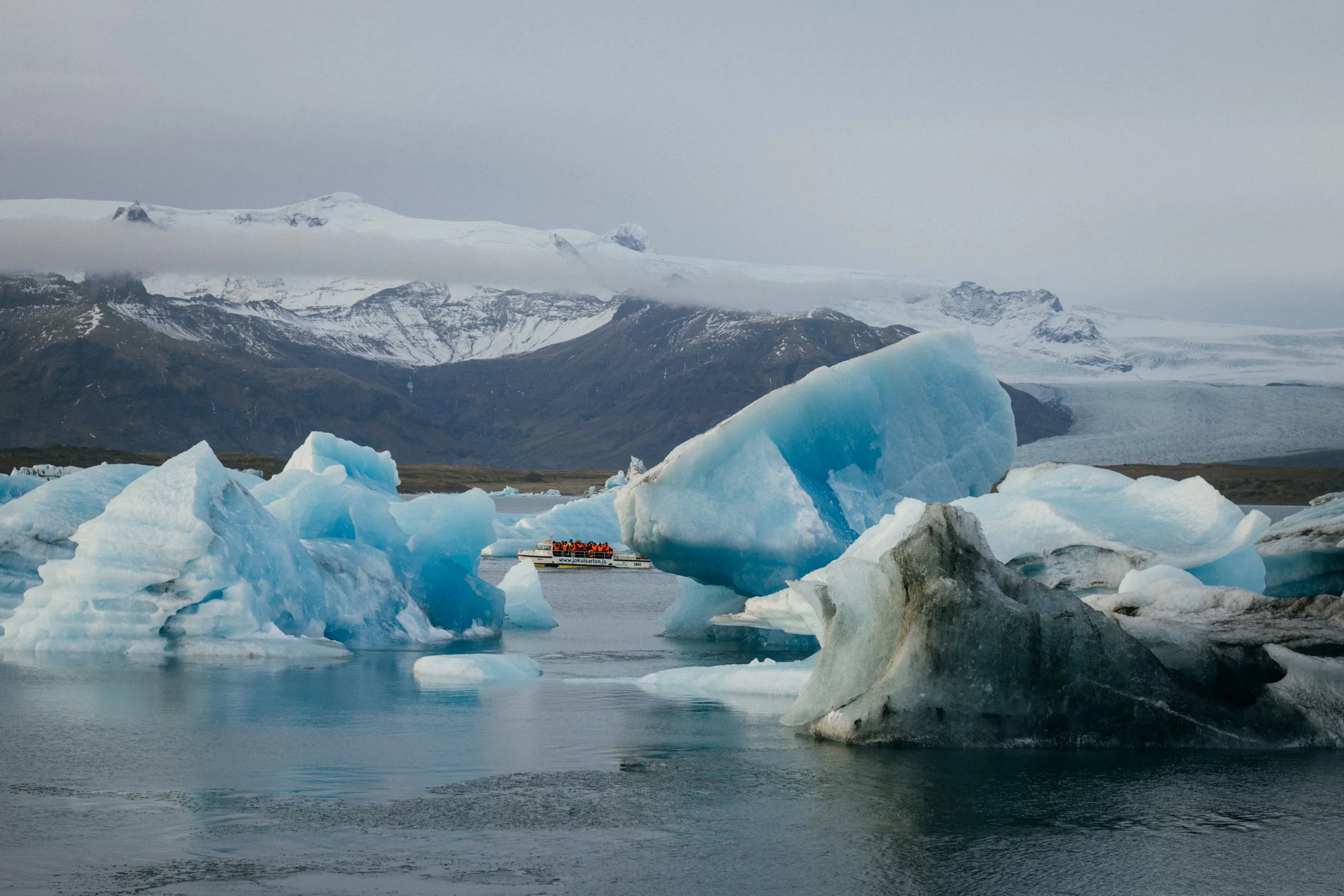 Blue icebergs drifting across a lagoon in Iceland
