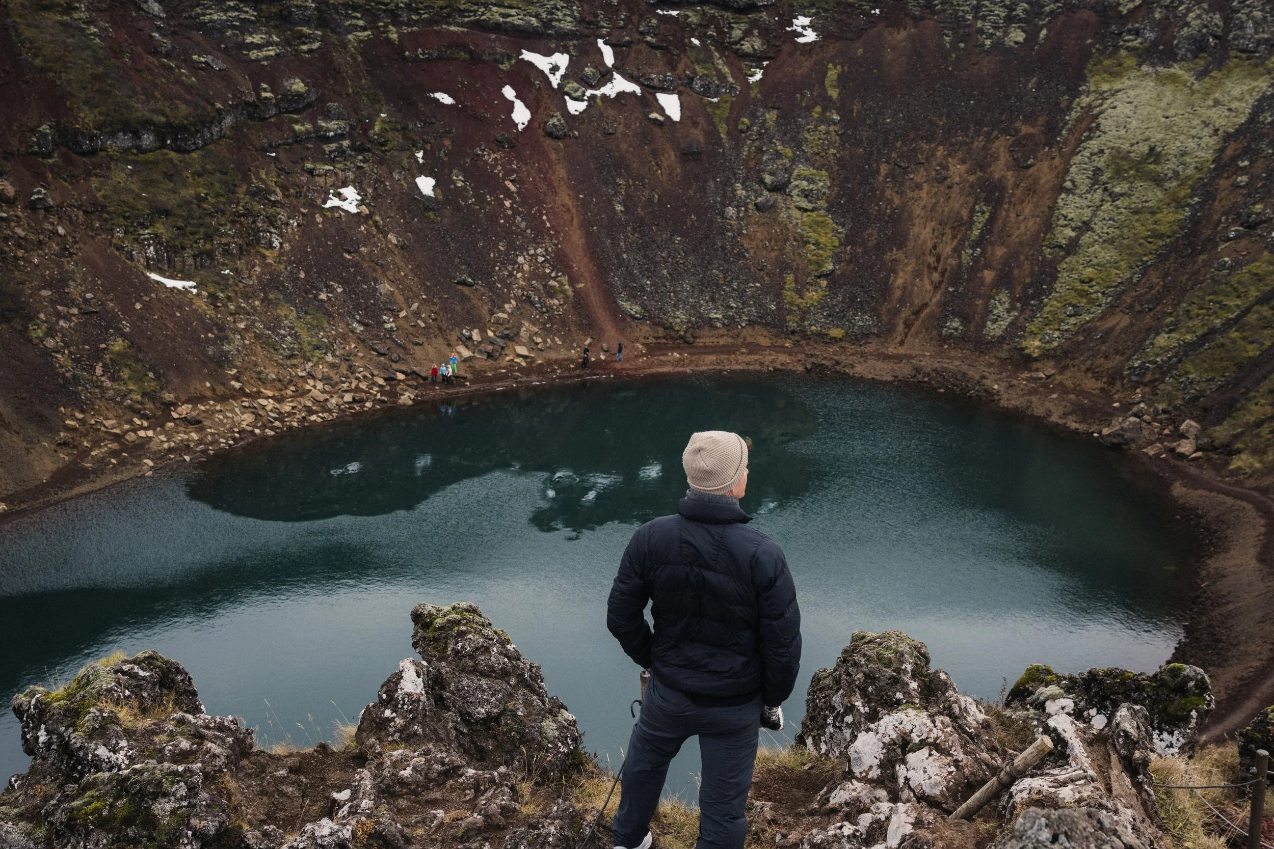 couple stopping at old lava pool along Iceland highway