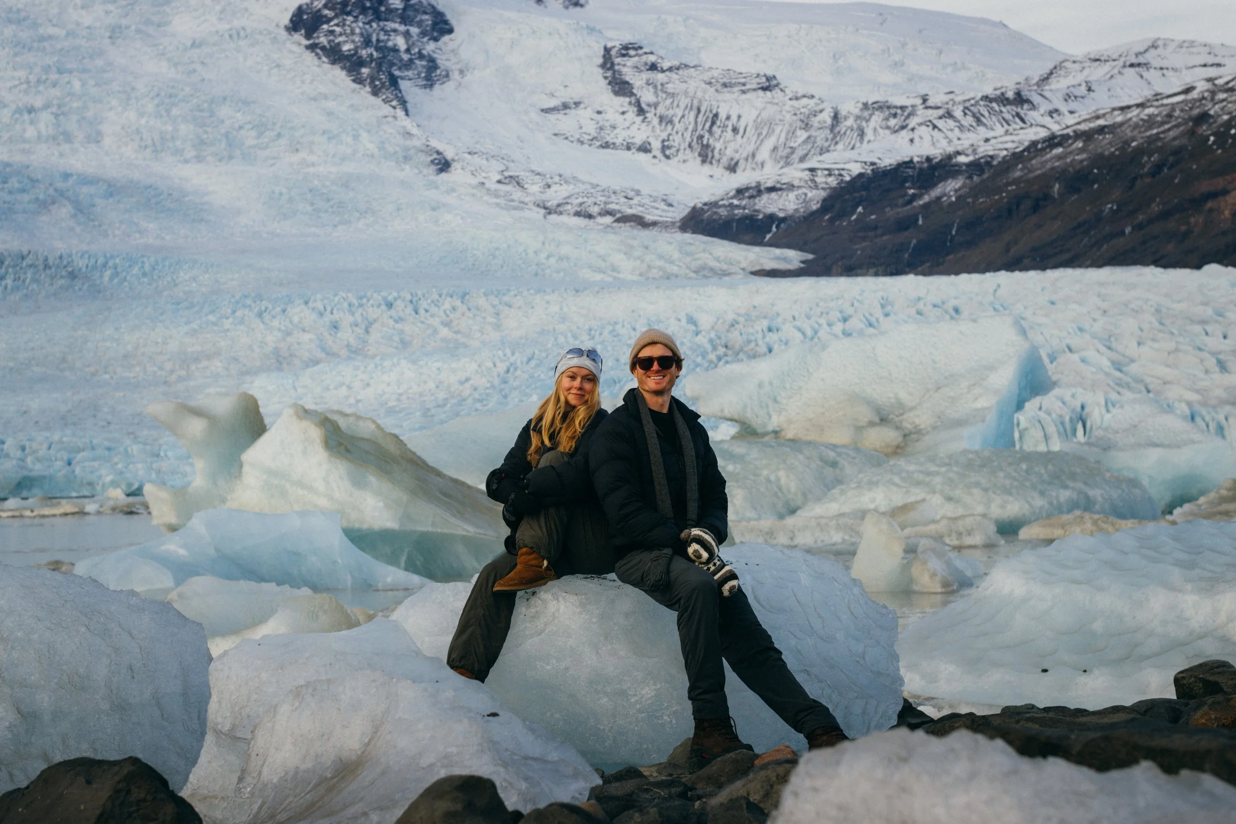 Couple photoshoot on dramatic glacier lagoon landscape in Iceland