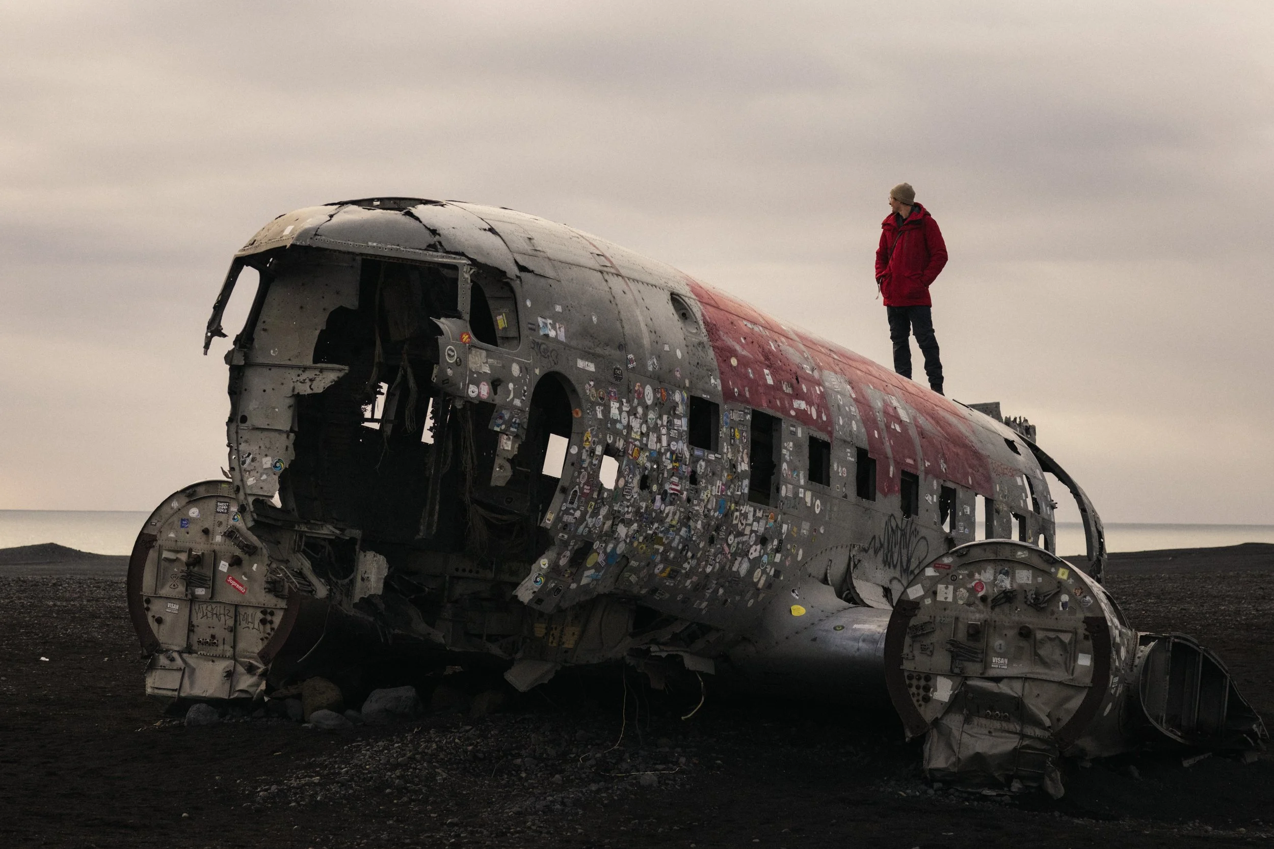 Campervan traveling along a scenic plane wreck in Iceland