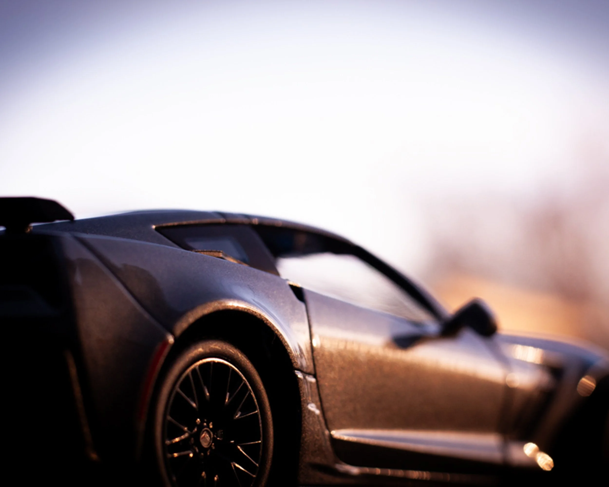 Close-up of a dark sports car with blurred background