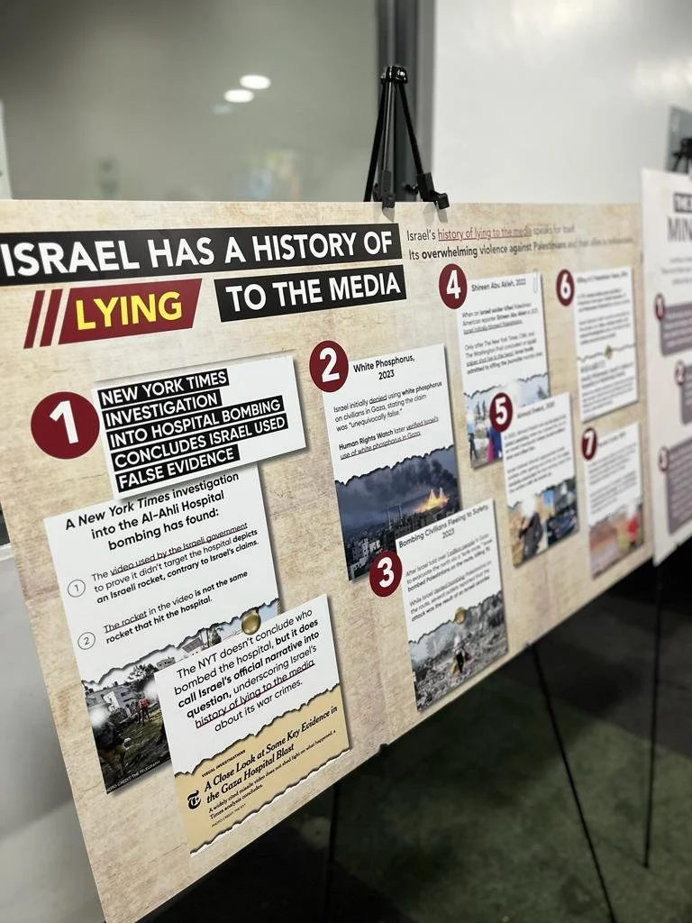 Display board presenting alleged false information about Israel's history with numbered points and photos, with the headline referencing Israel and media deception.