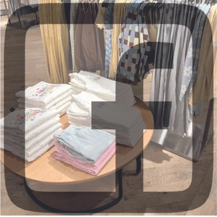 Cloth diapers arranged in stacks on a table in a clothing store.