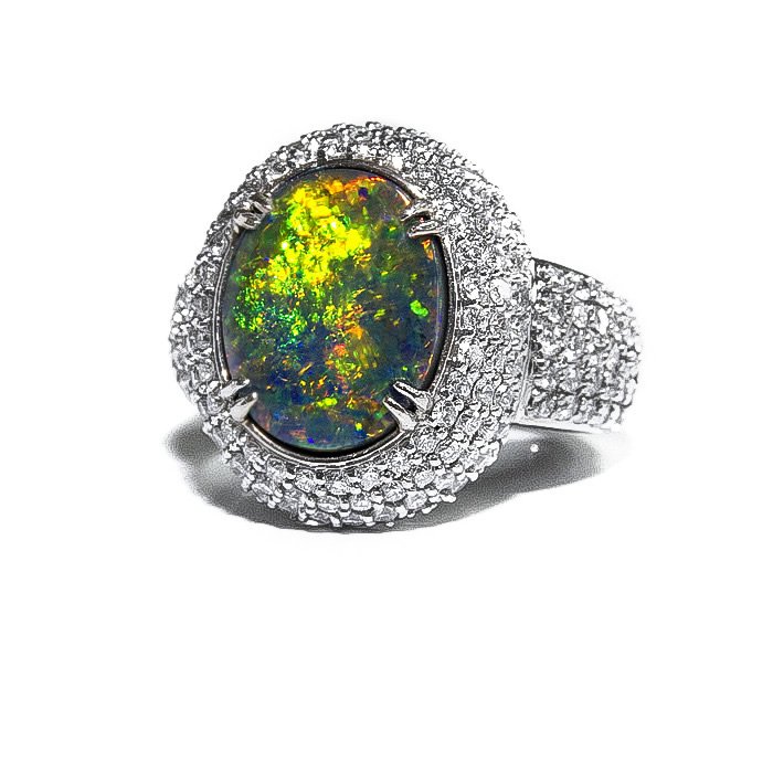 A silver ring with a large oval-shaped opal gemstone surrounded by small diamonds.