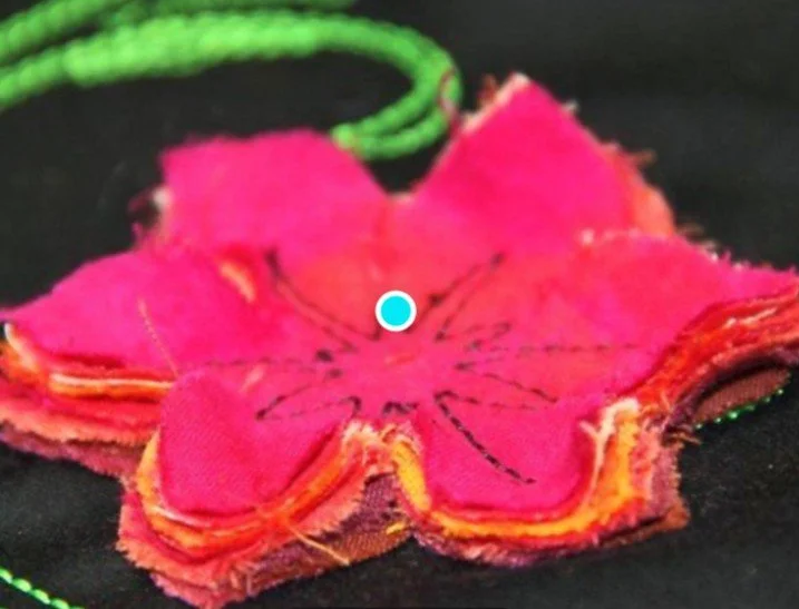 Advanced CutWork embroidery design featuring layered fabric petals cut and stitched using the BERNINA CutWork Tool.