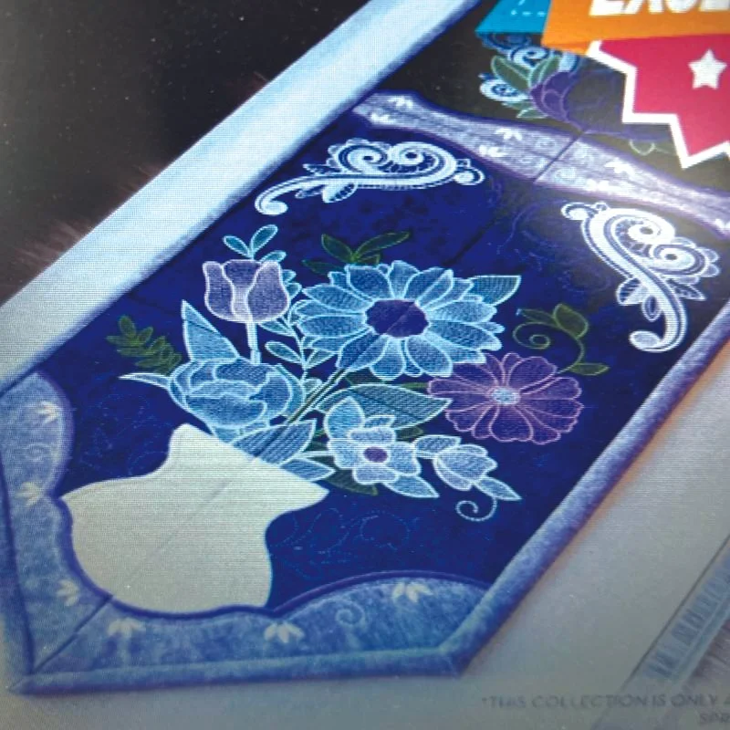 Machine embroidery project featuring floral stitching arranged in a tile-style layout, designed as a spring table runner.