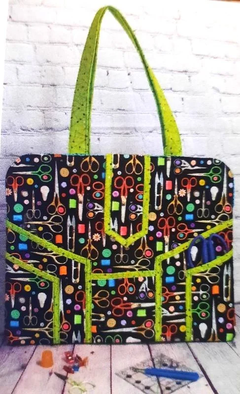 Modern mat bag sewing project featuring a multi-pocket fabric tote designed to hold cutting mats, rulers, and sewing tools