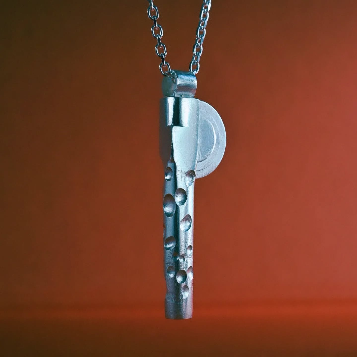 Welcome Form π
Entirely hand-fabricated in sterling silver, this piece explores balance, gesture, and spatial rhythm.
The vertical form anchors the eye, solid yet softened, while a series of half-spherical impressions cascade along one side like a
