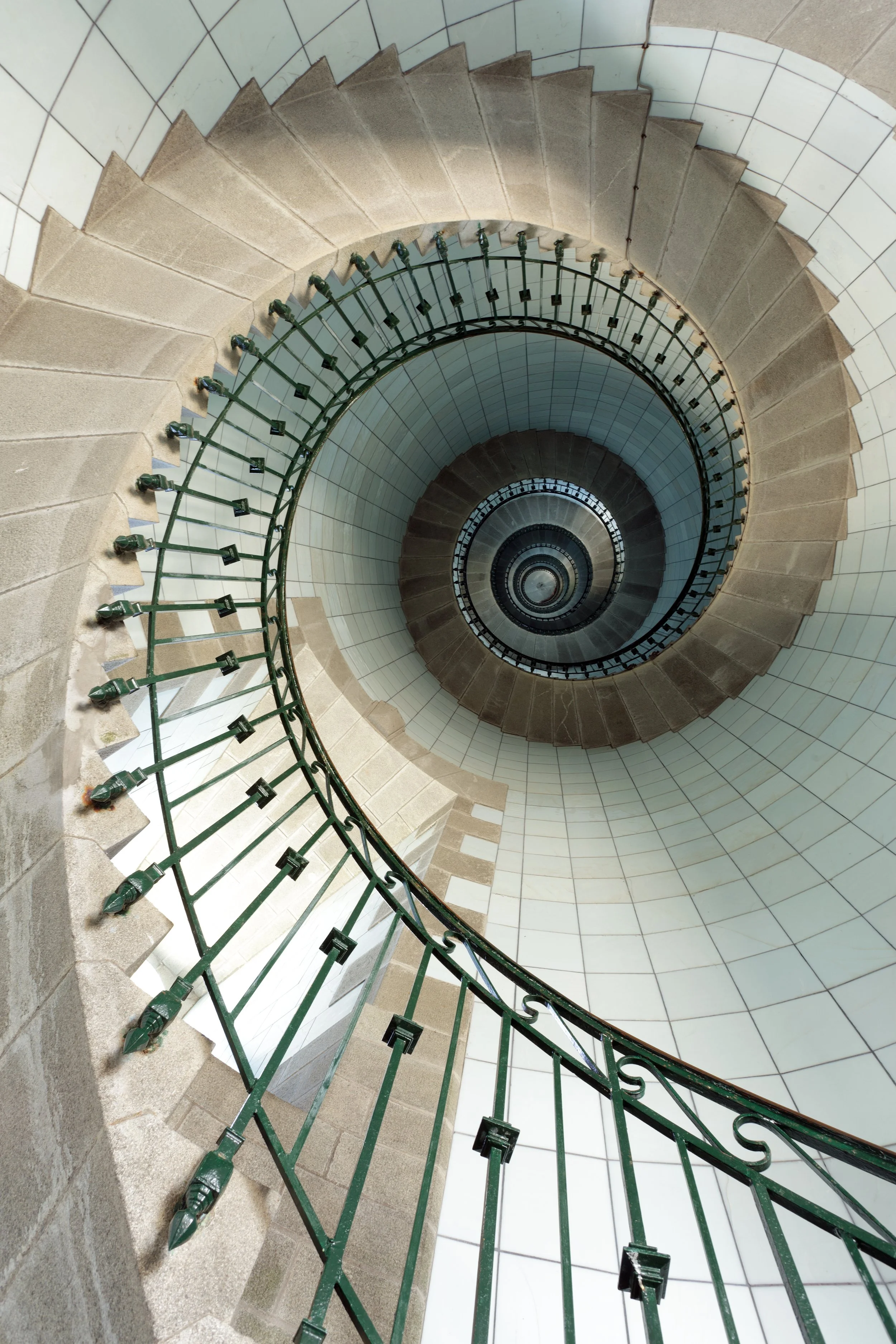Circular stone staircase winding upward, evoking the spiral path of awakening and spiritual renewal.