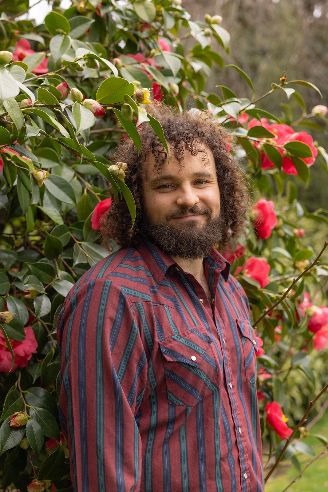Teague standing with some roses