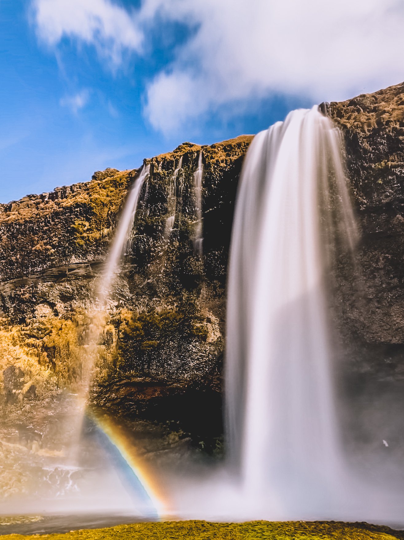 Seljelandsfoss Waterfall in Iceland with rainbow.