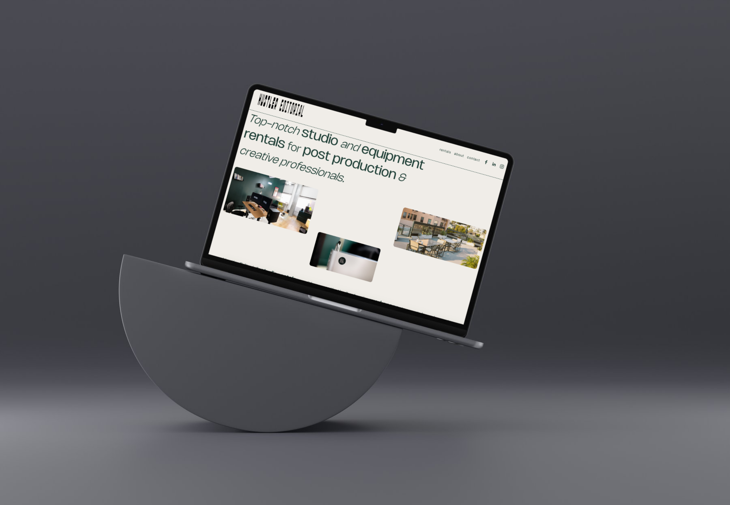 A laptop on a semi-circular stand displaying a website with text about studio and equipment rentals for post production and creative professionals.