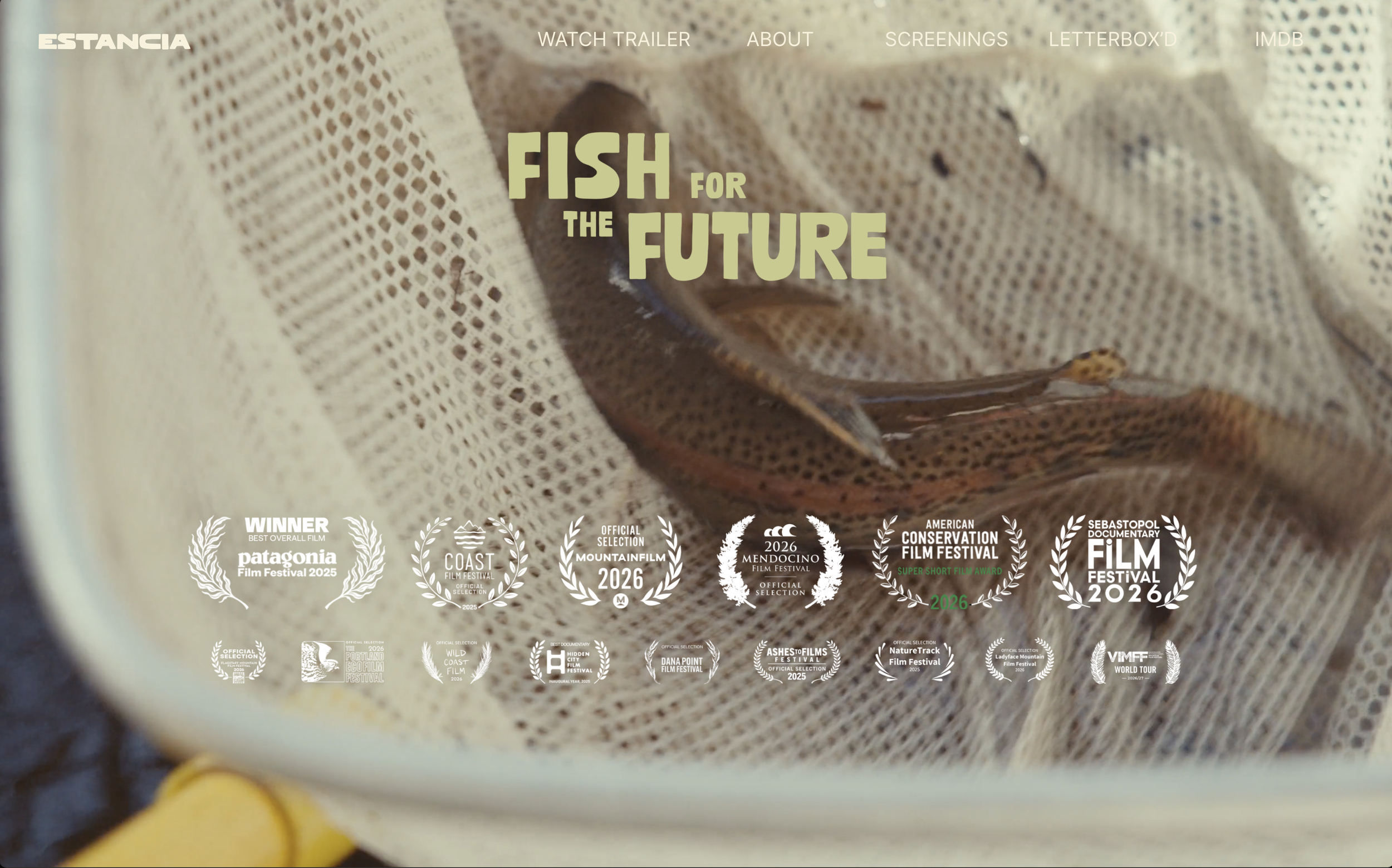 Close-up of a snake inside a fabric or net enclosure, with event festival awards and logos displayed at the bottom.