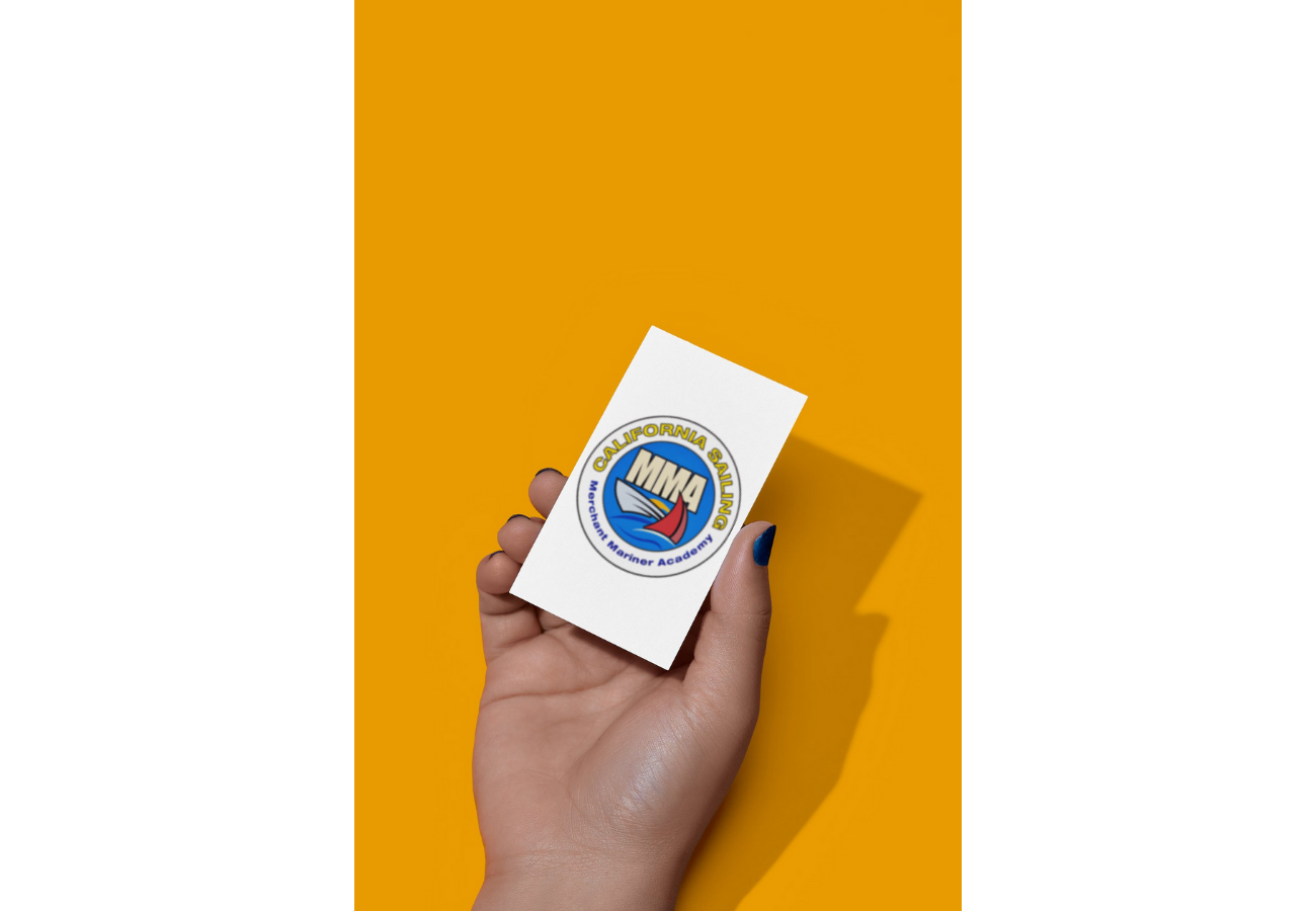 Hand holding a card with the MMA California Sailing logo against an orange background.