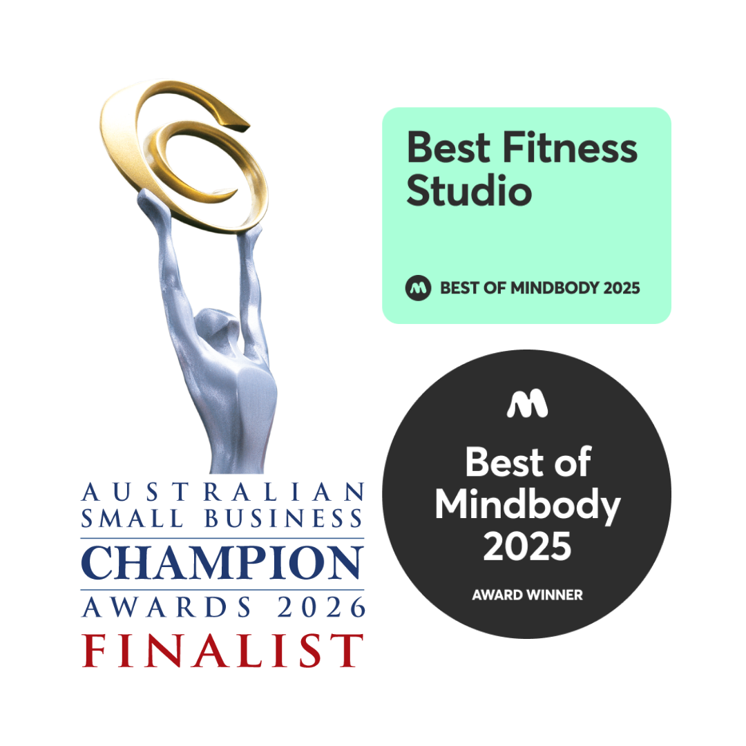 An award with a silver hand holding a gold ring, and text indicating it is for Best Fitness Studio at the 2025 Mindbody awards, with logos and ribbons.
