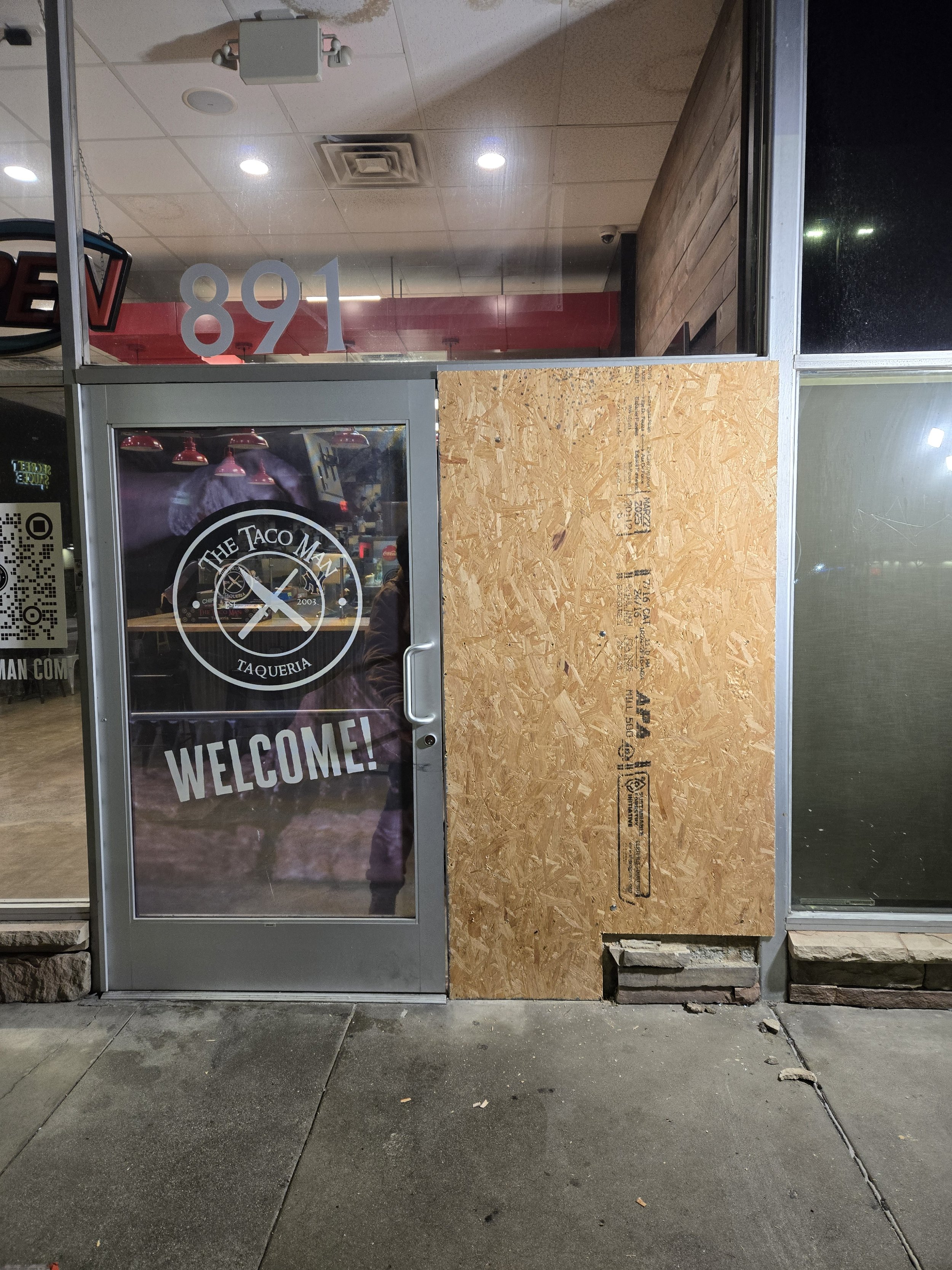 Storefront window board-up in Los Angeles — plywood on damaged side 
window while keeping the entry door open for business. After-hours 
service by Boardup LA.
