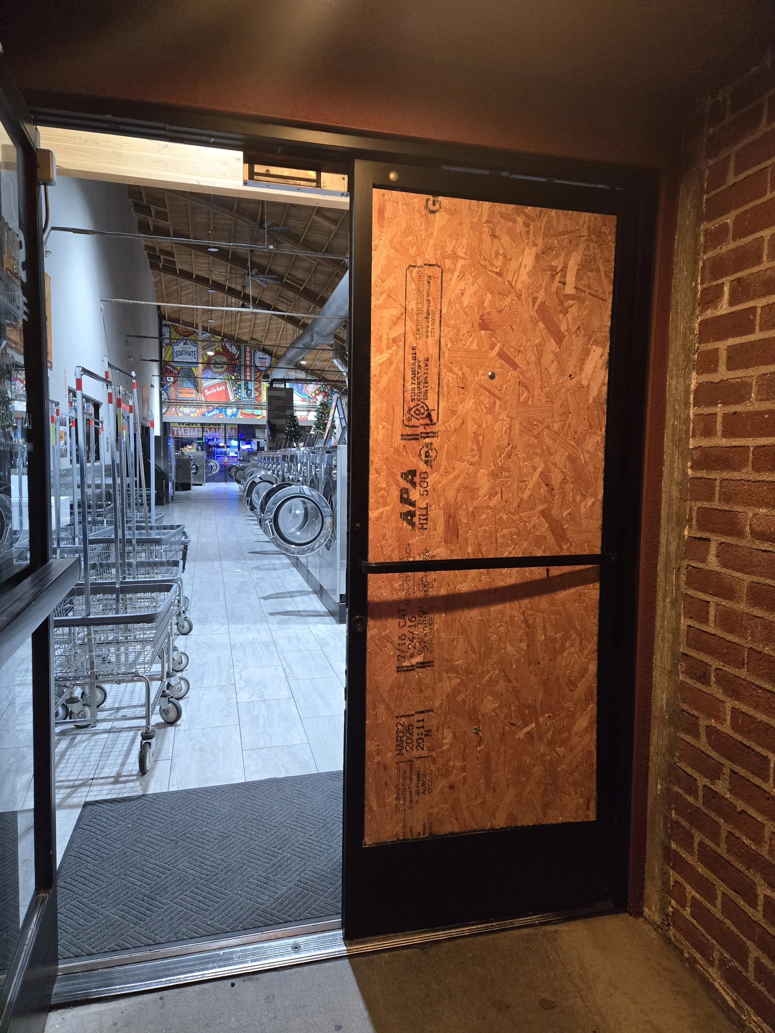 Commercial entry board-up in Los Angeles — plywood on one door 
panel while keeping the other open for business access. Same-day 
service by Boardup LA.