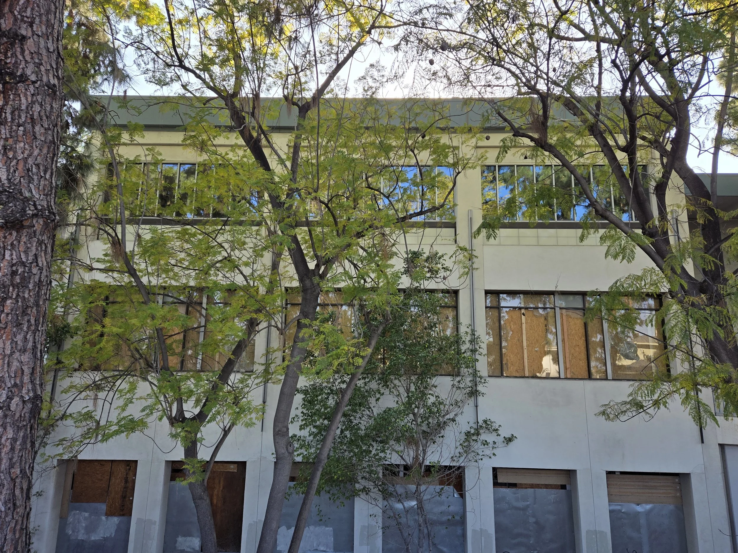 Multi-floor building board-up in Los Angeles — plywood securing 
units across three levels of a commercial building. Multi-unit 
service by Boardup LA.