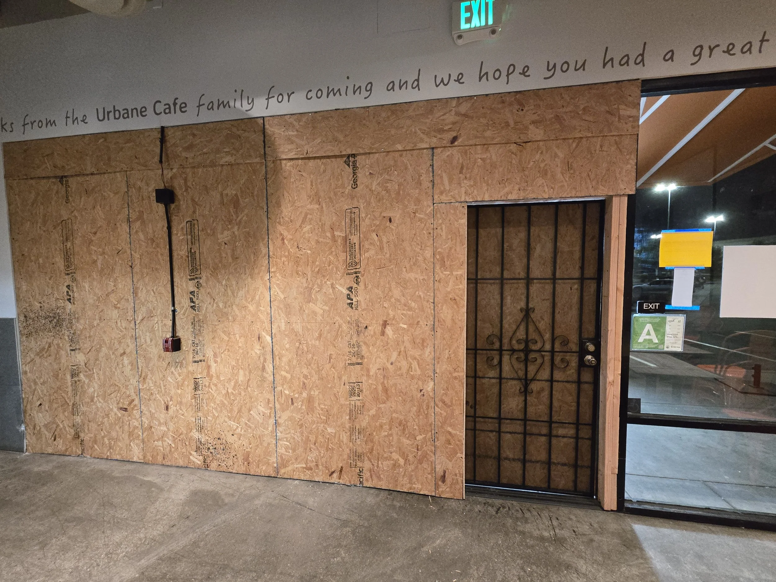 Restaurant storefront board-up in Los Angeles — full-front plywood 
installation at a local cafe with security gate access maintained. 
Commercial emergency service by Boardup LA.