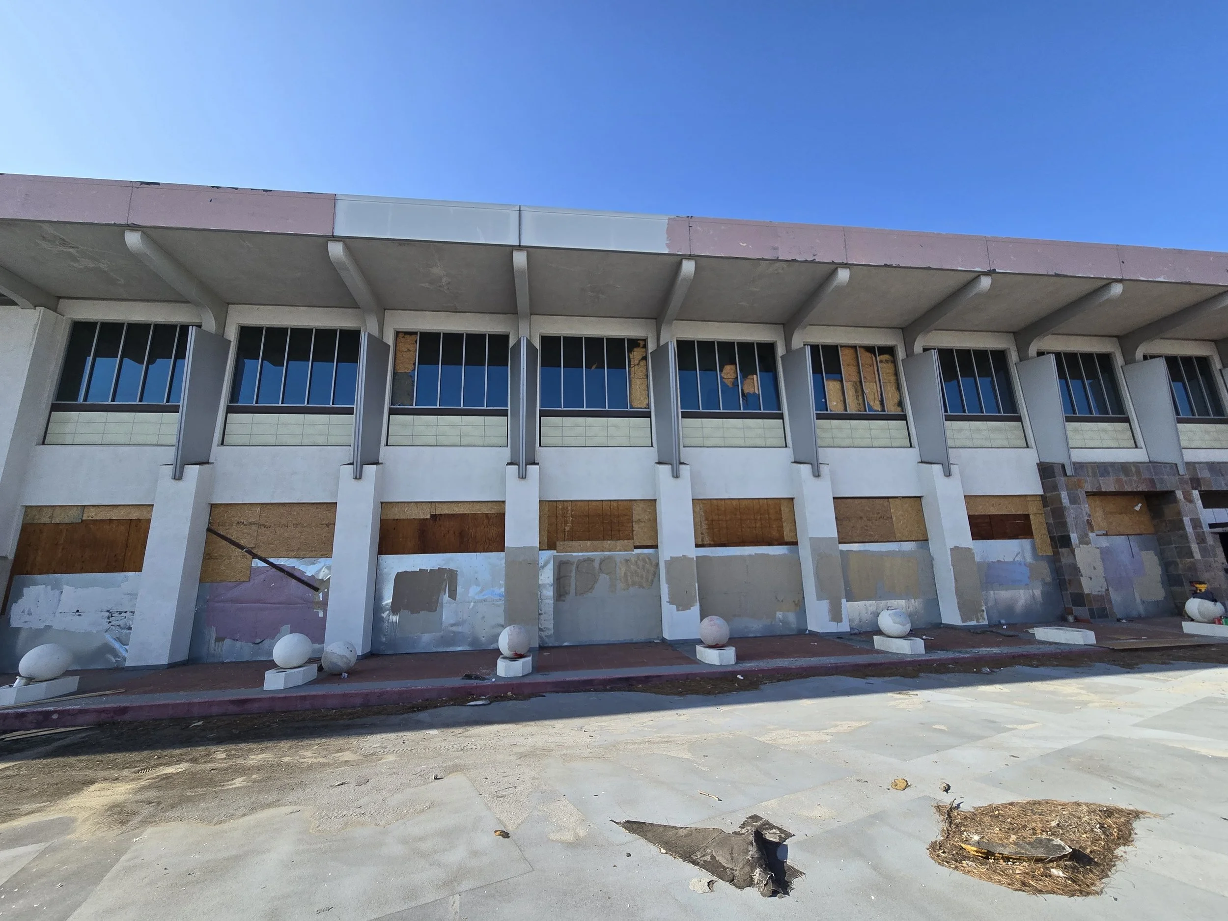 Full-building commercial board-up in Los Angeles — multi-story 
plywood installation securing all ground-level entries and upper 
windows on a vacant property. Large-scale service by Boardup LA.