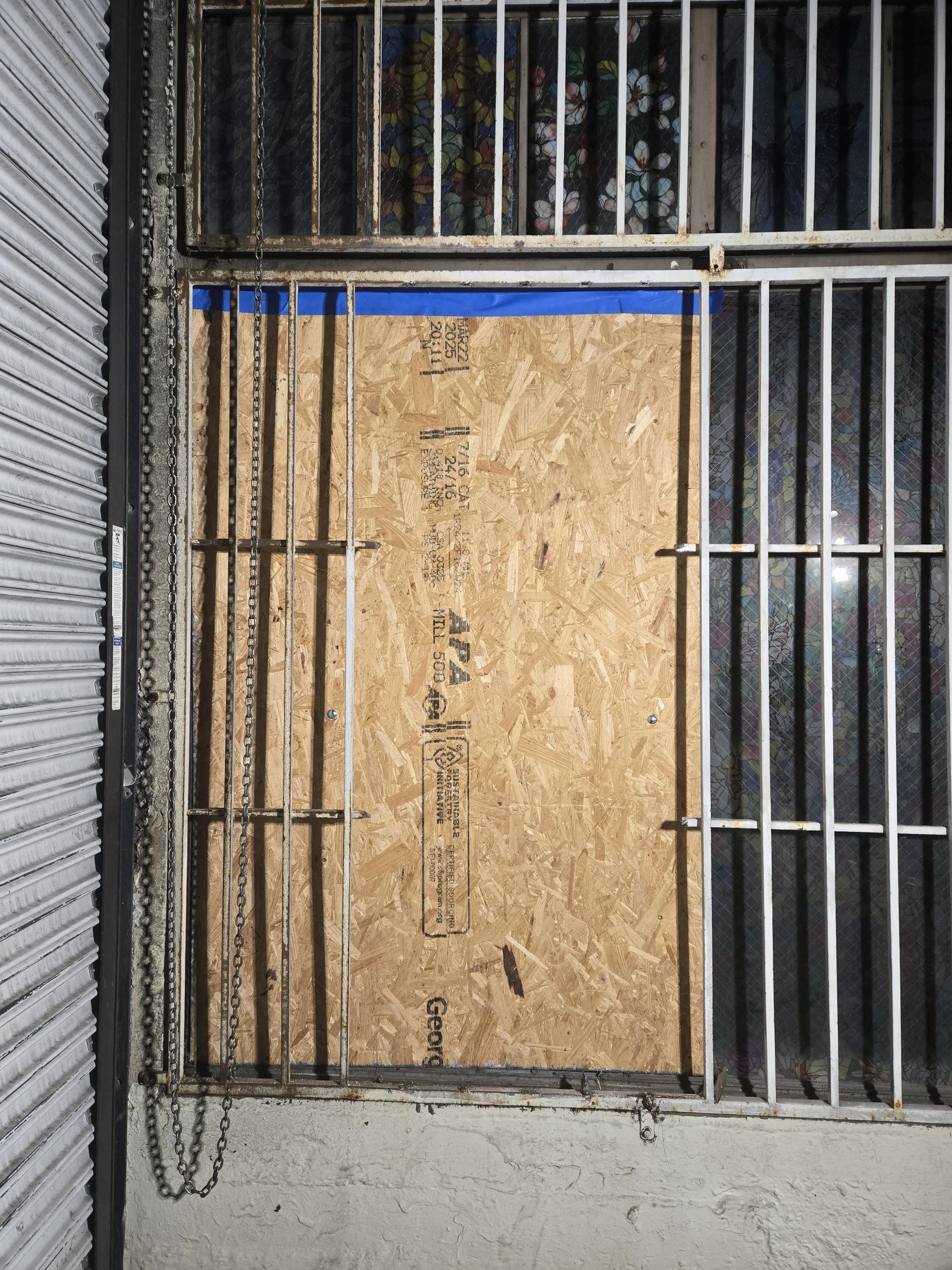 Secured entry board-up in Los Angeles — plywood installed behind 
existing security gate for double-layer protection. Emergency 
service by Boardup LA.