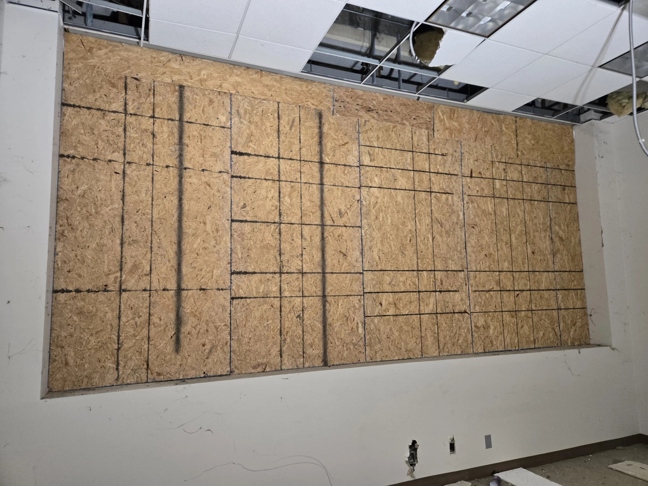 Large interior wall board-up in Los Angeles — full-height plywood 
installation across a commercial space with clean, professional 
finish. Restoration-grade service by Boardup LA.