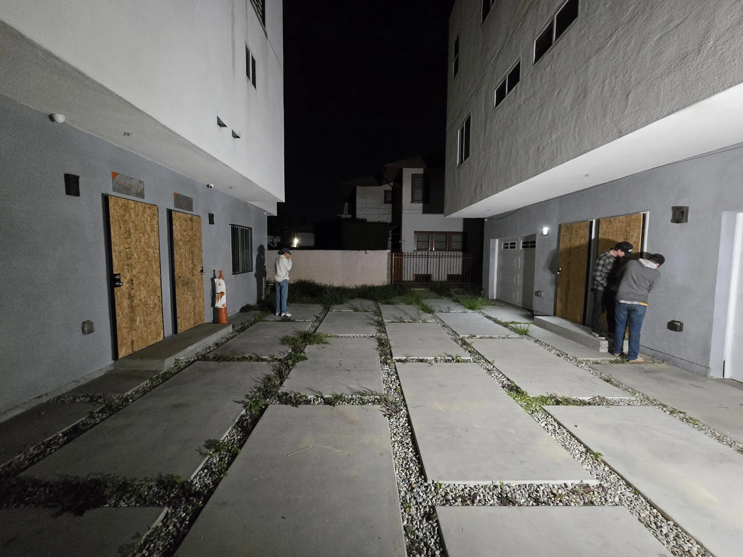 Multi-building board-up in Los Angeles — simultaneous plywood 
installation across two adjacent properties at night. Large-scale 
emergency response by Boardup LA's crew.