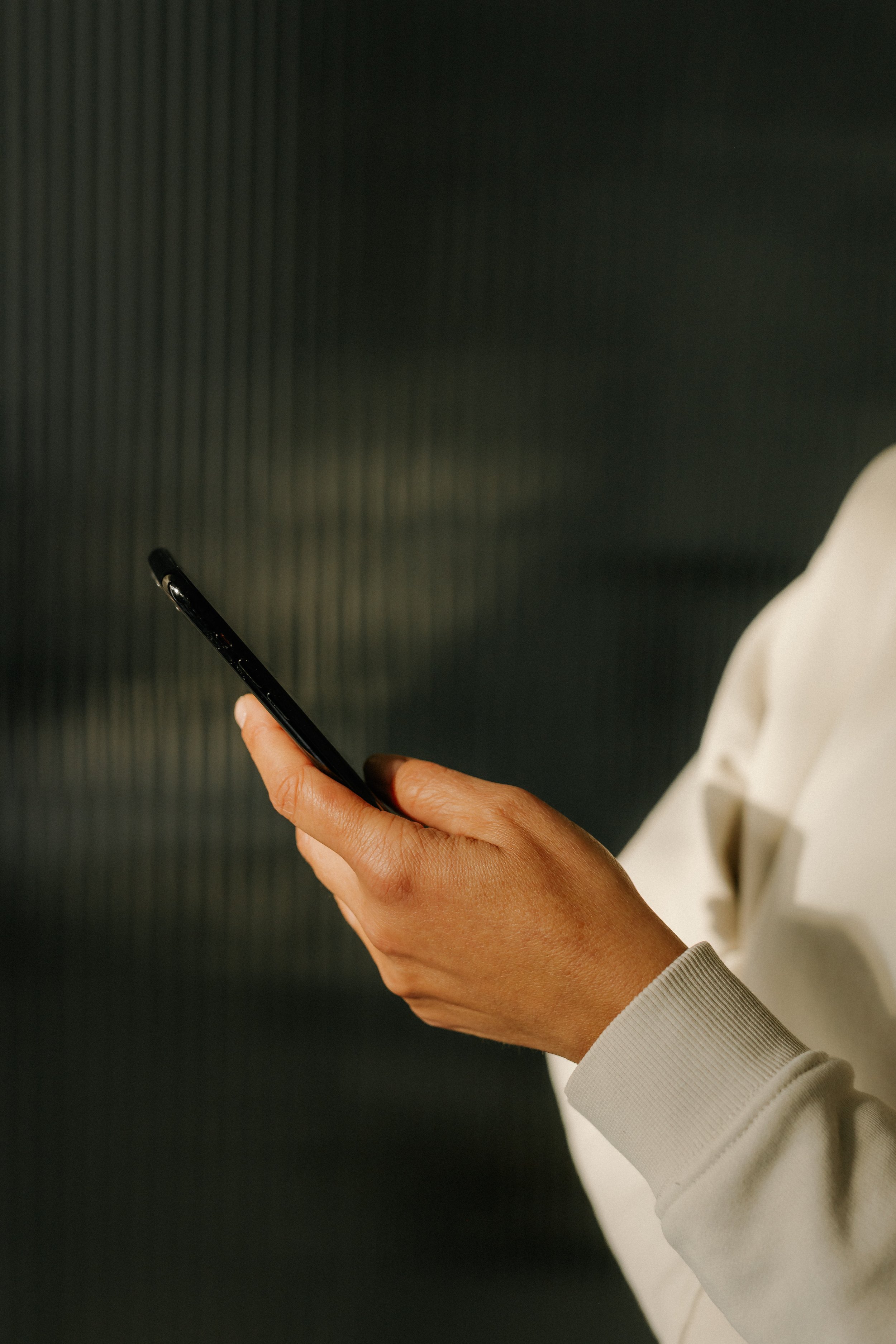 Closeup view of someone holding and checking their smartphone