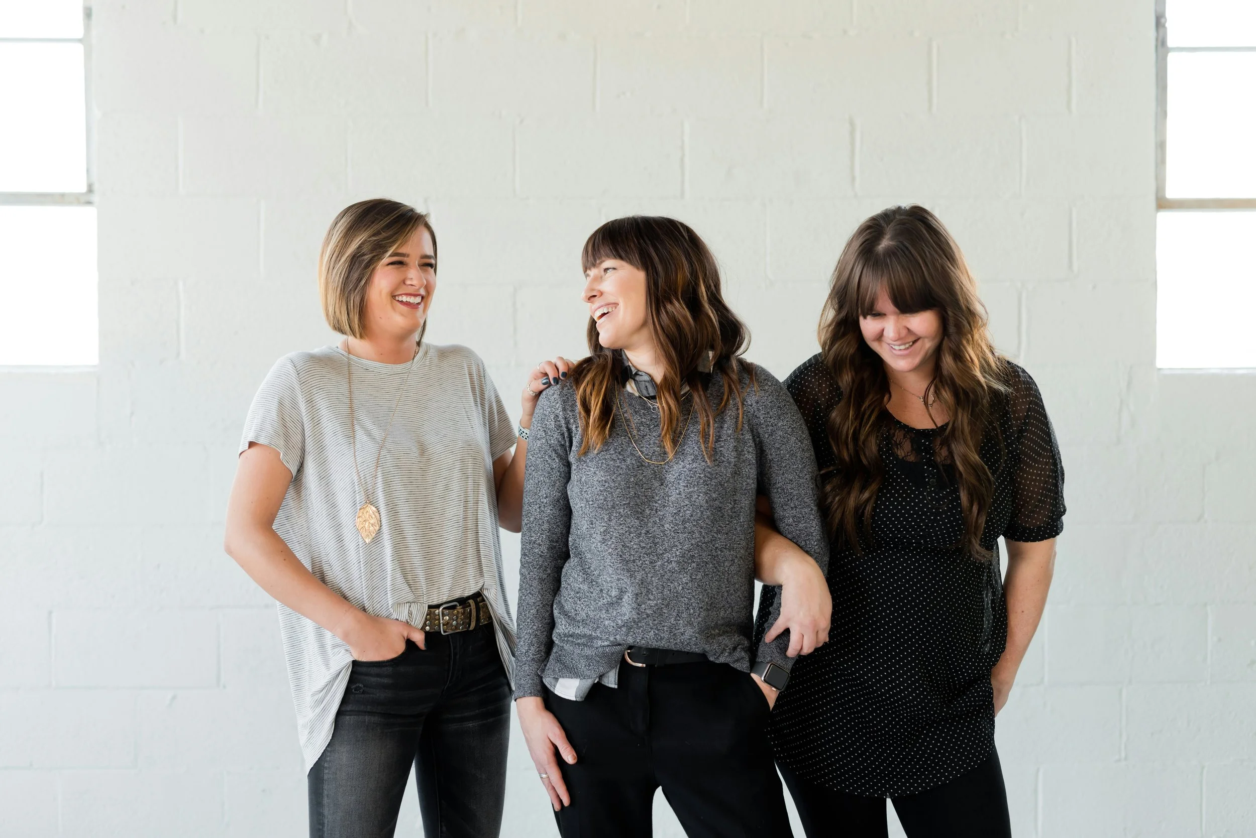 Group of three smiling entrepreneur women talking and smiling