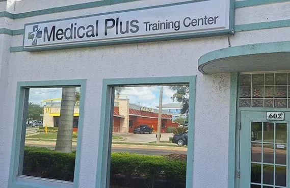 Exterior of Medical Plus Training Center in Fort Pierce, Florida, showing the clinic entrance and building sign.