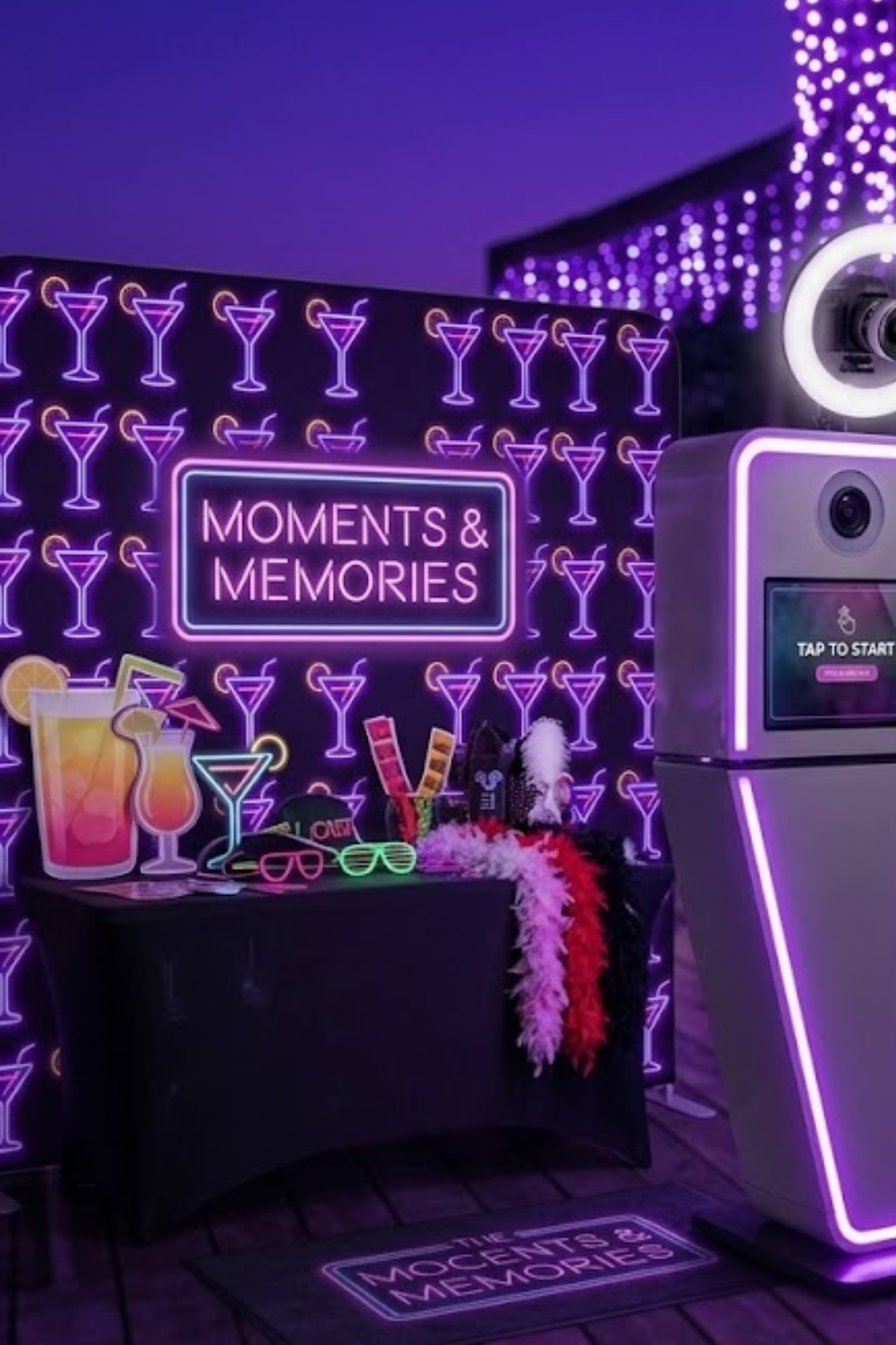 Neon-lit photo booth with a sign reading "Moments & Memories", decorated with neon cocktail glasses and leis, and a floor sign that says "The Most Important Memories".